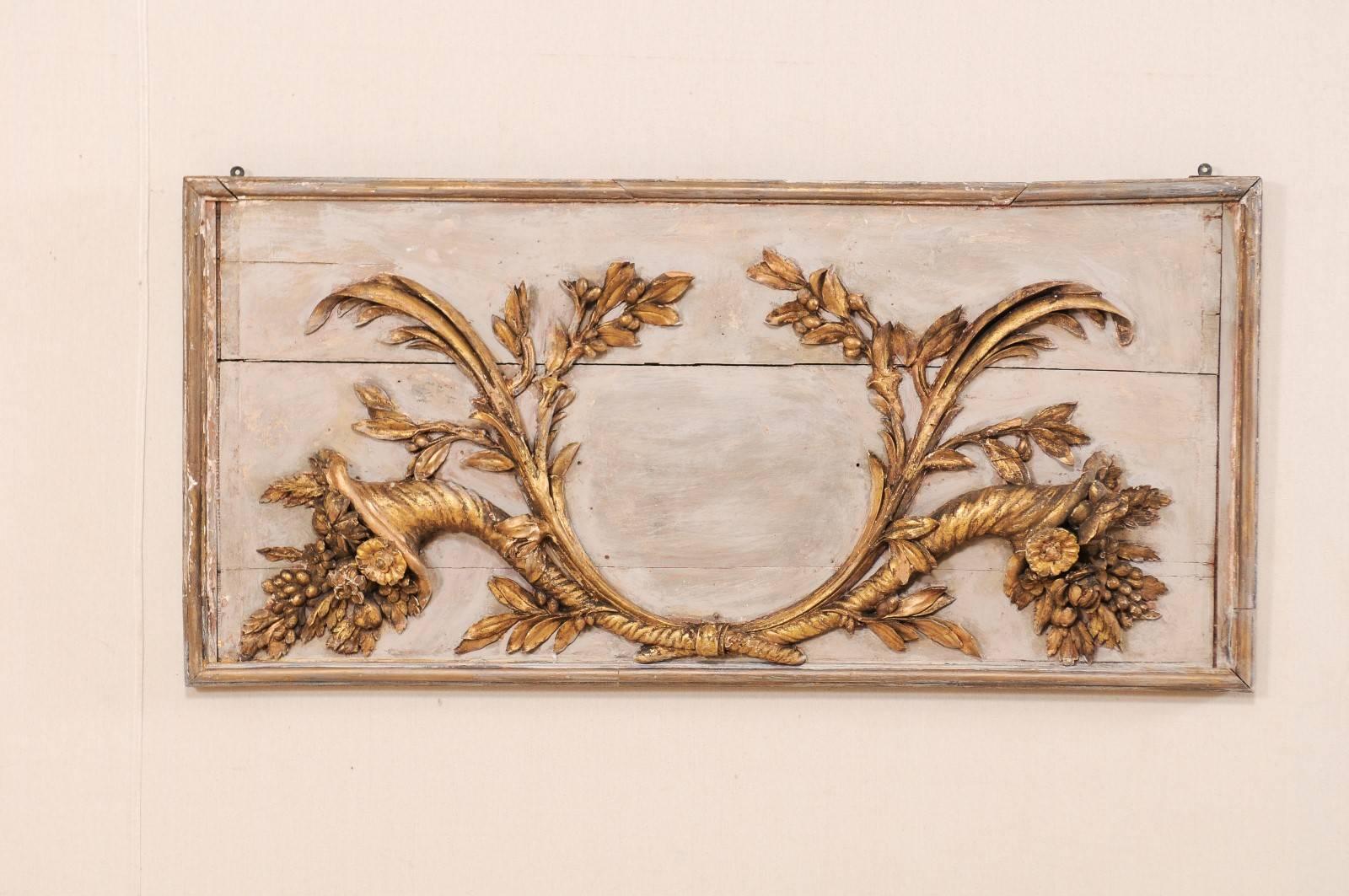 An 18th century Italian wood carved decorative hanging wall plaque. This rectangular shaped Italian wall decoration features a three dimensional pair of exquisitely carved cornicello affixed to a wooden plaque. The cornicello baskets are textured