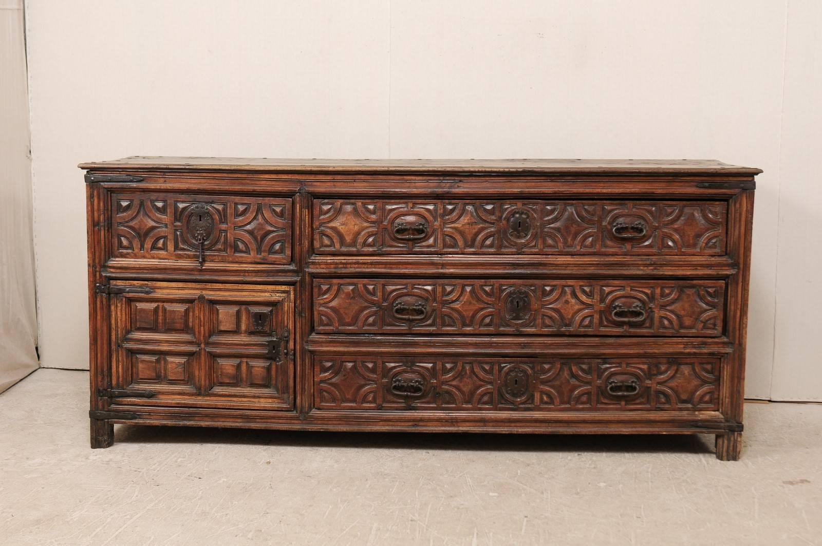 An impressive 18th century Spanish wood carved sacristy chest. This oversized sacristy chest comes from an old church in Spain and dates back to the 18th century, possibly 17th century. This is an exquisite piece with richly carved geometric shapes