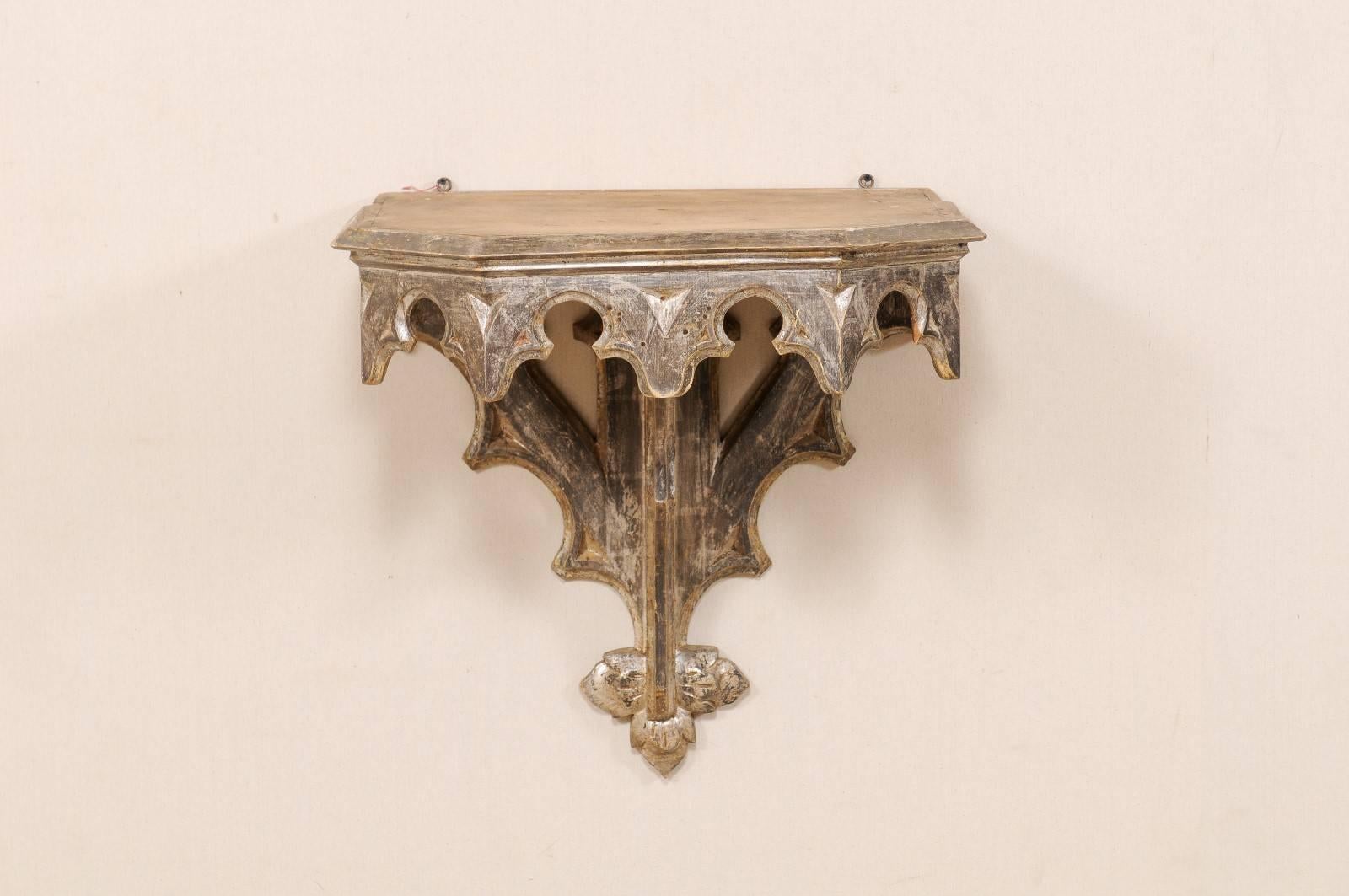 An early 19th century, Italian wall-mounted table. This Italian table from the early 19th century features a silver gilt finish, heavily carved skirt and support braces. The top is more unfinished and natural. This Italian wall mounted table would