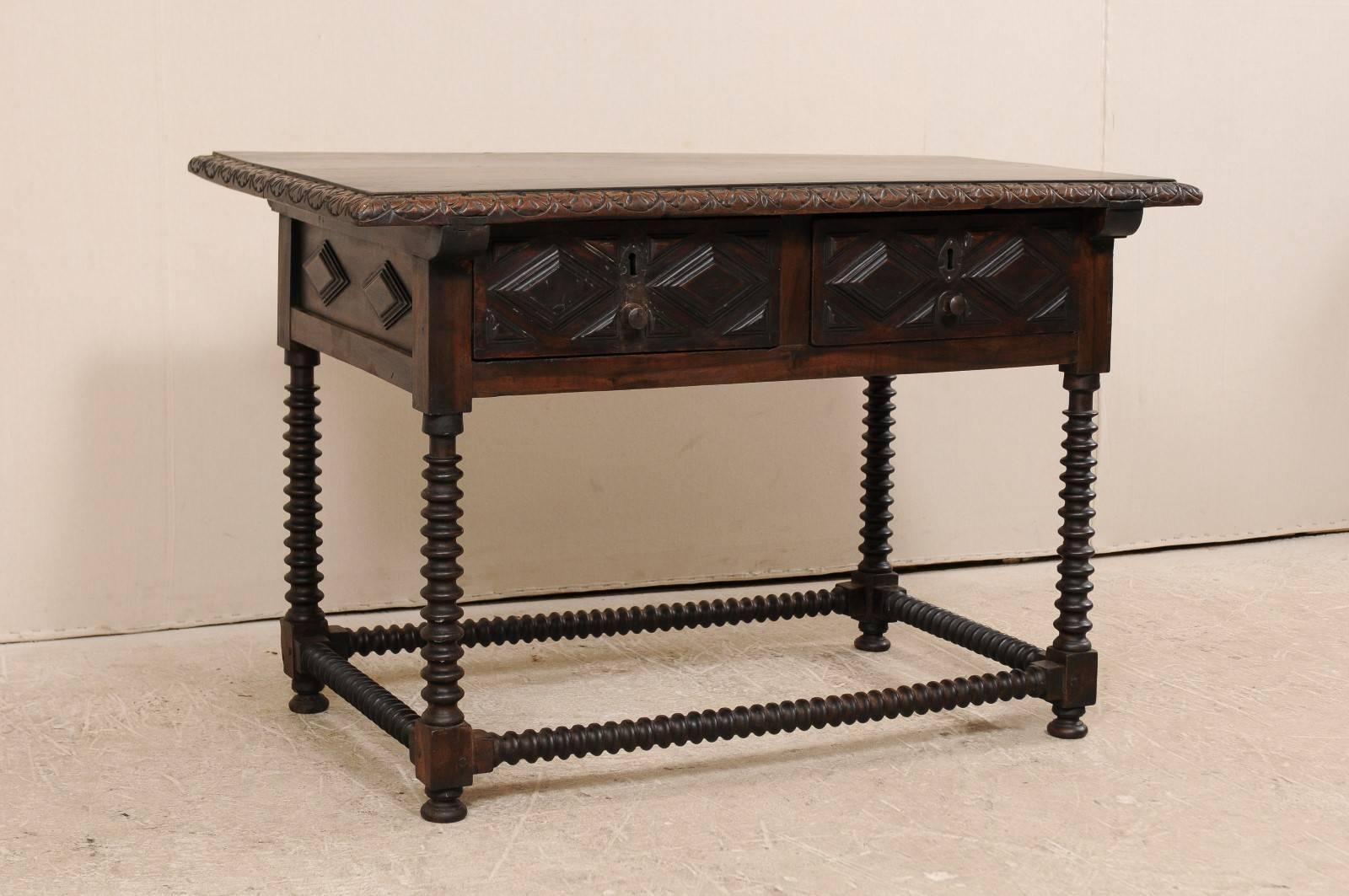 A Spanish early 18th century desk or table. This handsome Spanish desk of walnut features great carving and two large drawers. Amazing carved detail in this desk from the frieze trim around the top to the diamond and geometric carvings along the