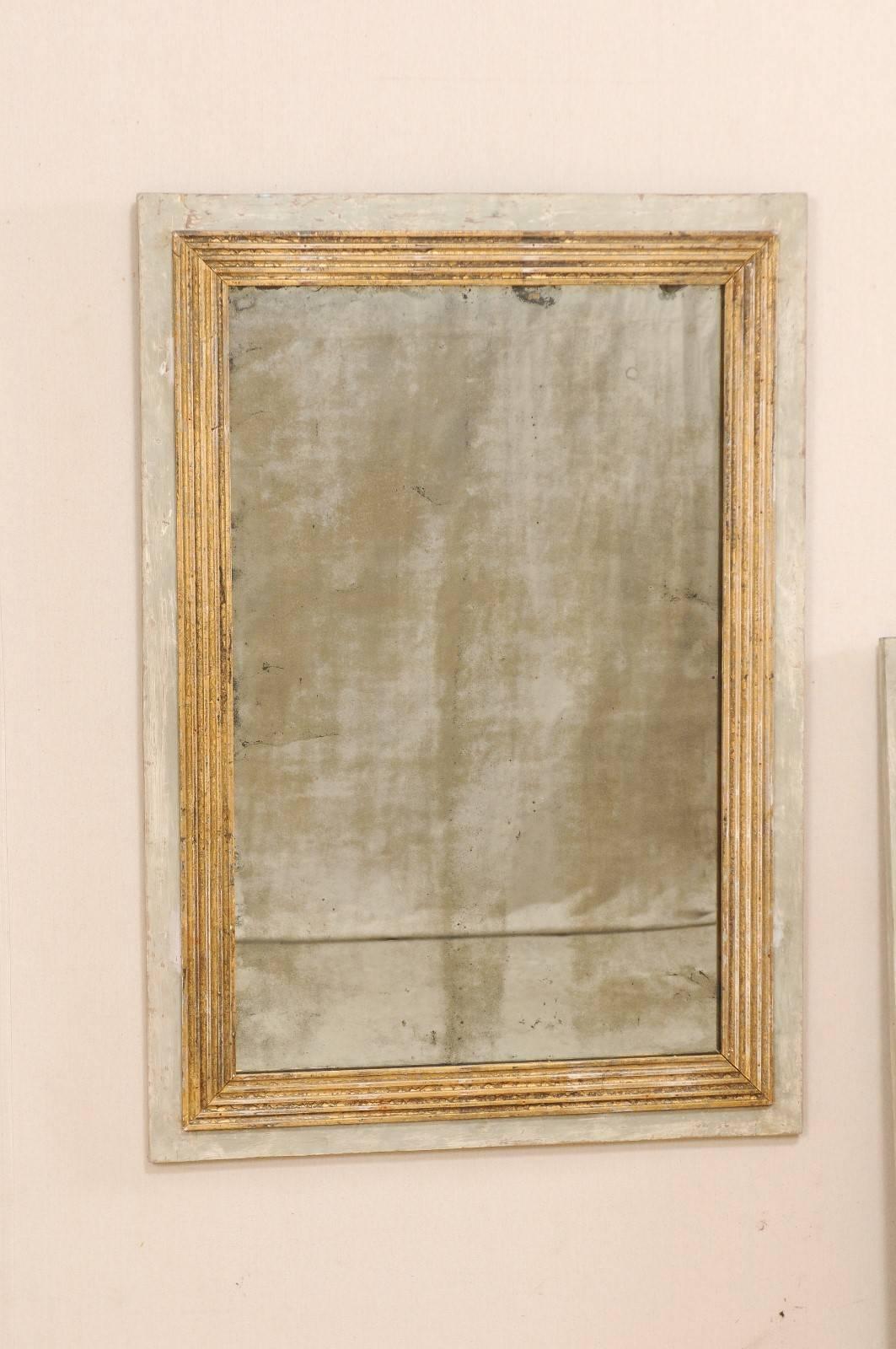 A pair of French 19th century painted wood mirrors. This pair of antique French mirrors is simple and elegant in design, with emphasis around their inner surround which features straight-lined reeded molding framed within a clean outer frame. These