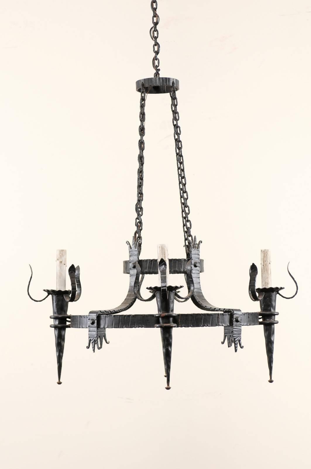 French Vintage Four-Light Black Iron Chandelier with Torch Shaped Arms For Sale 1