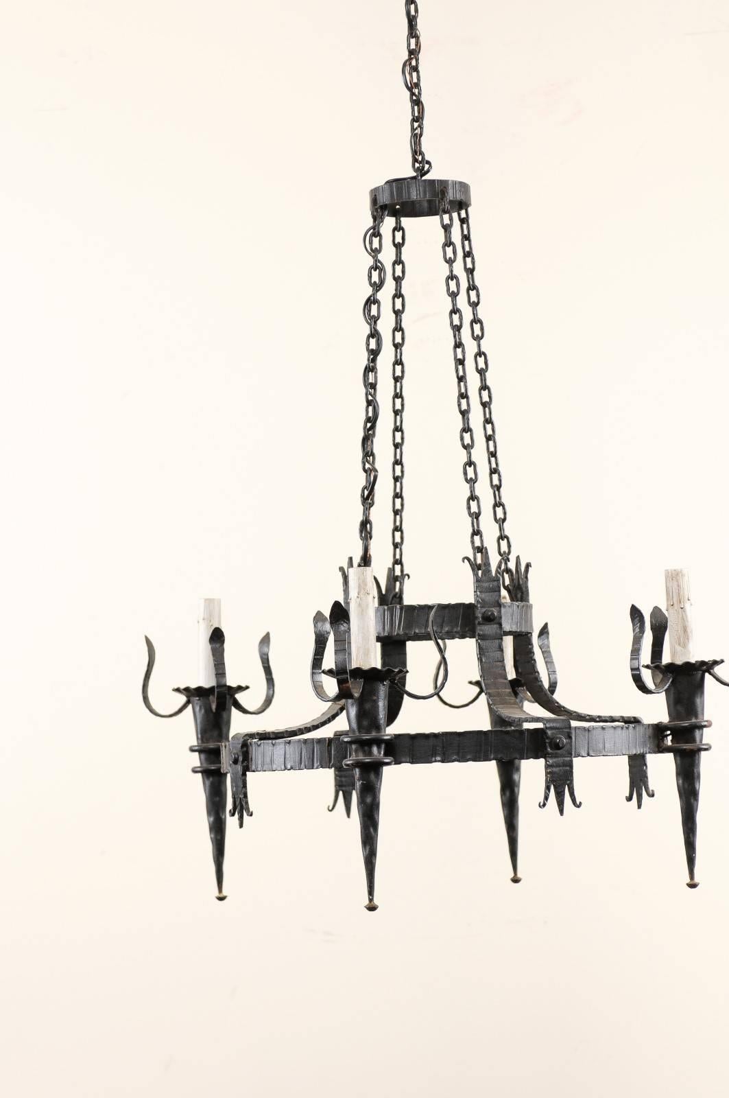 French Vintage Four-Light Black Iron Chandelier with Torch Shaped Arms In Good Condition For Sale In Atlanta, GA