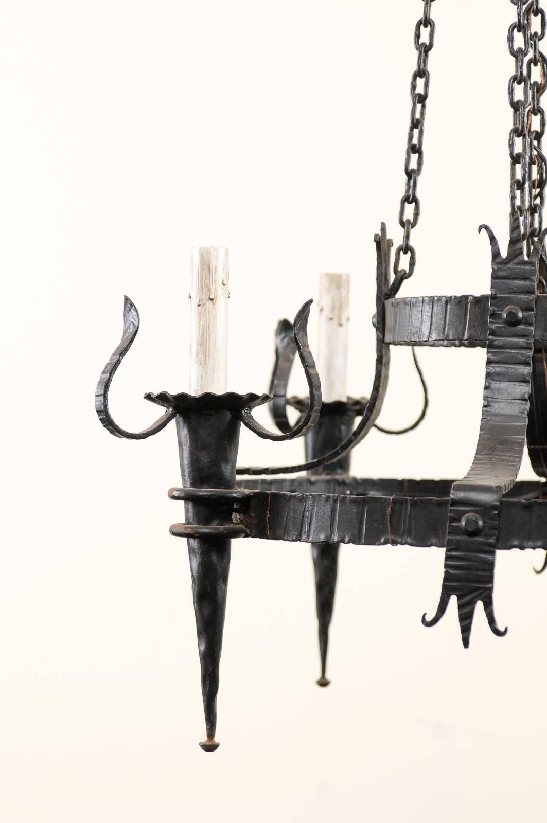 Rustic French Vintage Four-Light Black Iron Chandelier with Torch Shaped Arms For Sale