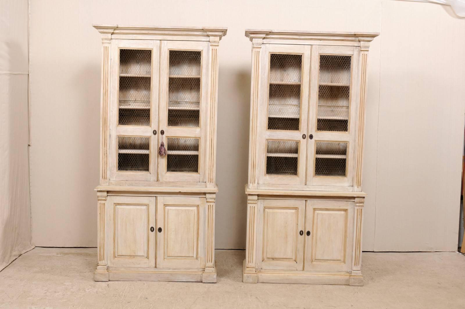 A pair of French 19th century tall cabinets. These antique French buffet à deux-corps (which is the name for a French buffet consisting of an upper and lower case, 