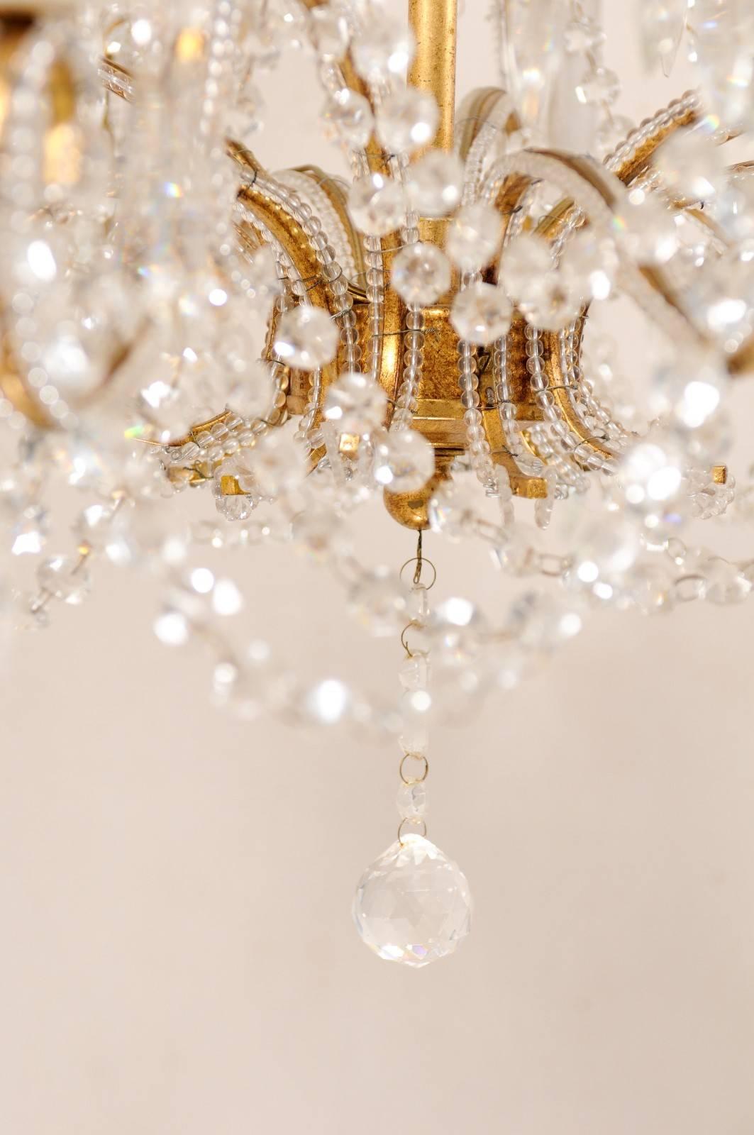 French Mid-20th Century Twelve-Light Crystal Chandelier with Gilded Iron Arms 2