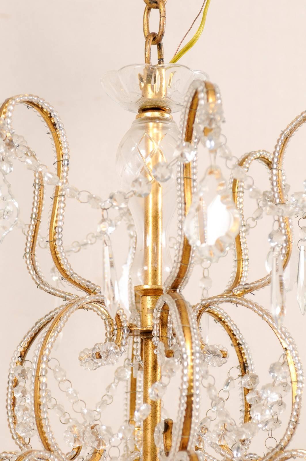 Gilt French Mid-20th Century Twelve-Light Crystal Chandelier with Gilded Iron Arms