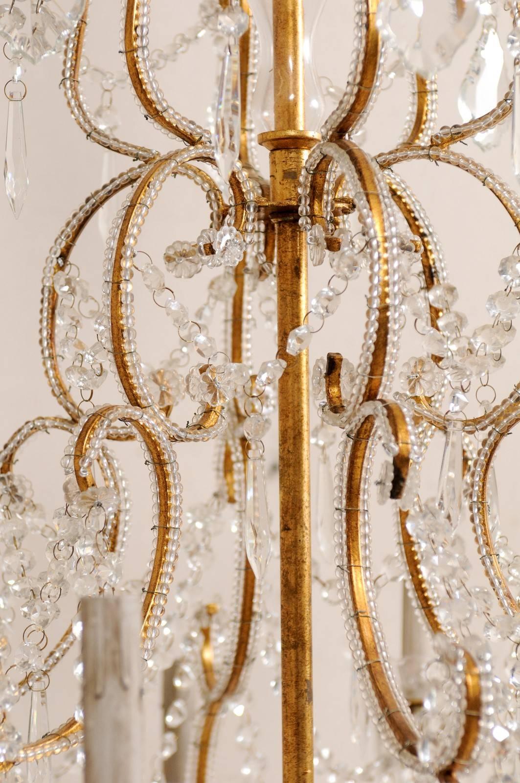 French Mid-20th Century Twelve-Light Crystal Chandelier with Gilded Iron Arms In Good Condition In Atlanta, GA