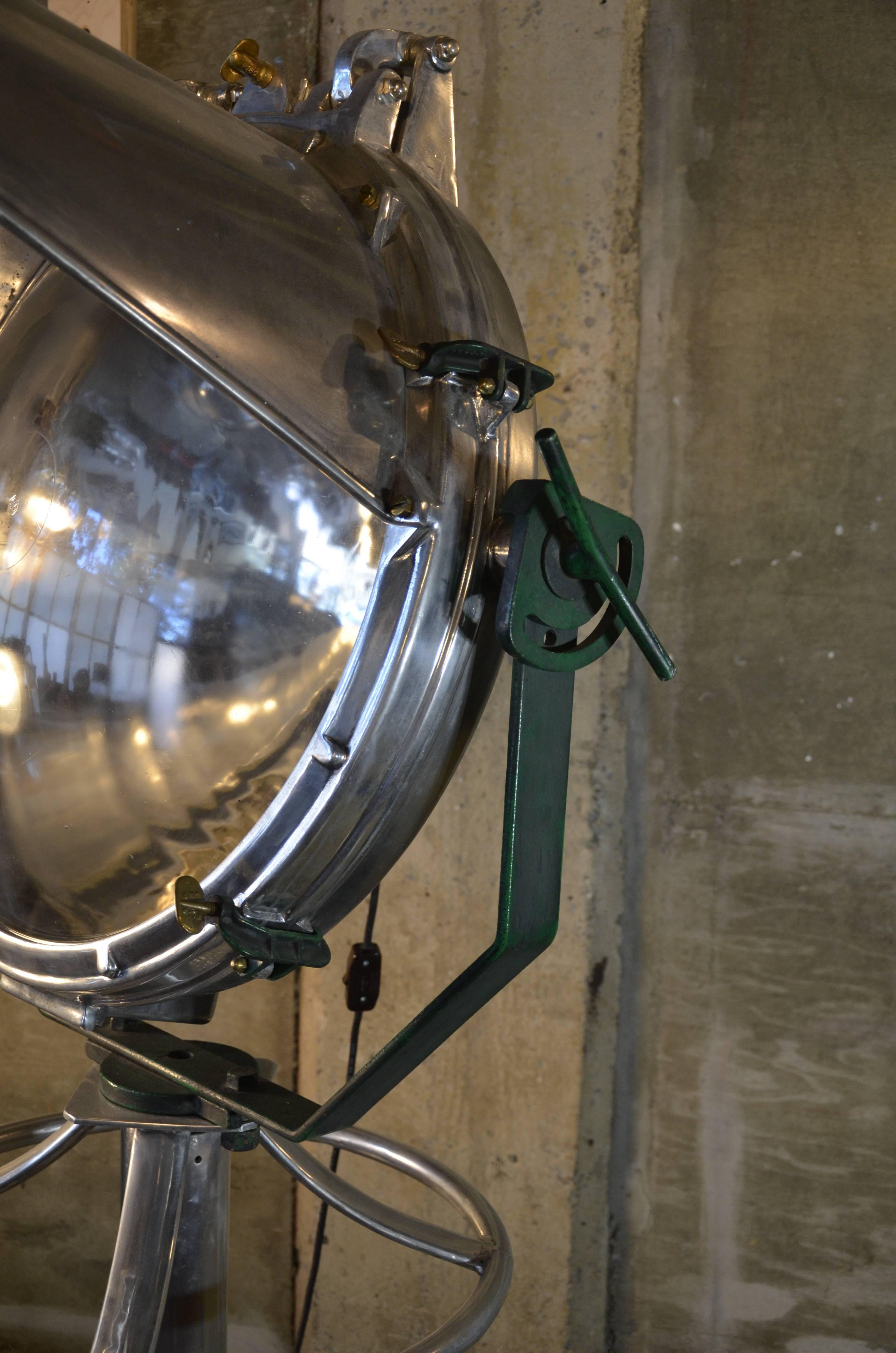 Exceptionally large Industrial spot light made of polished mixed metals, and mounted to a heavy duty carridge for easy transport. Fitted for standard incandescent fixtures.