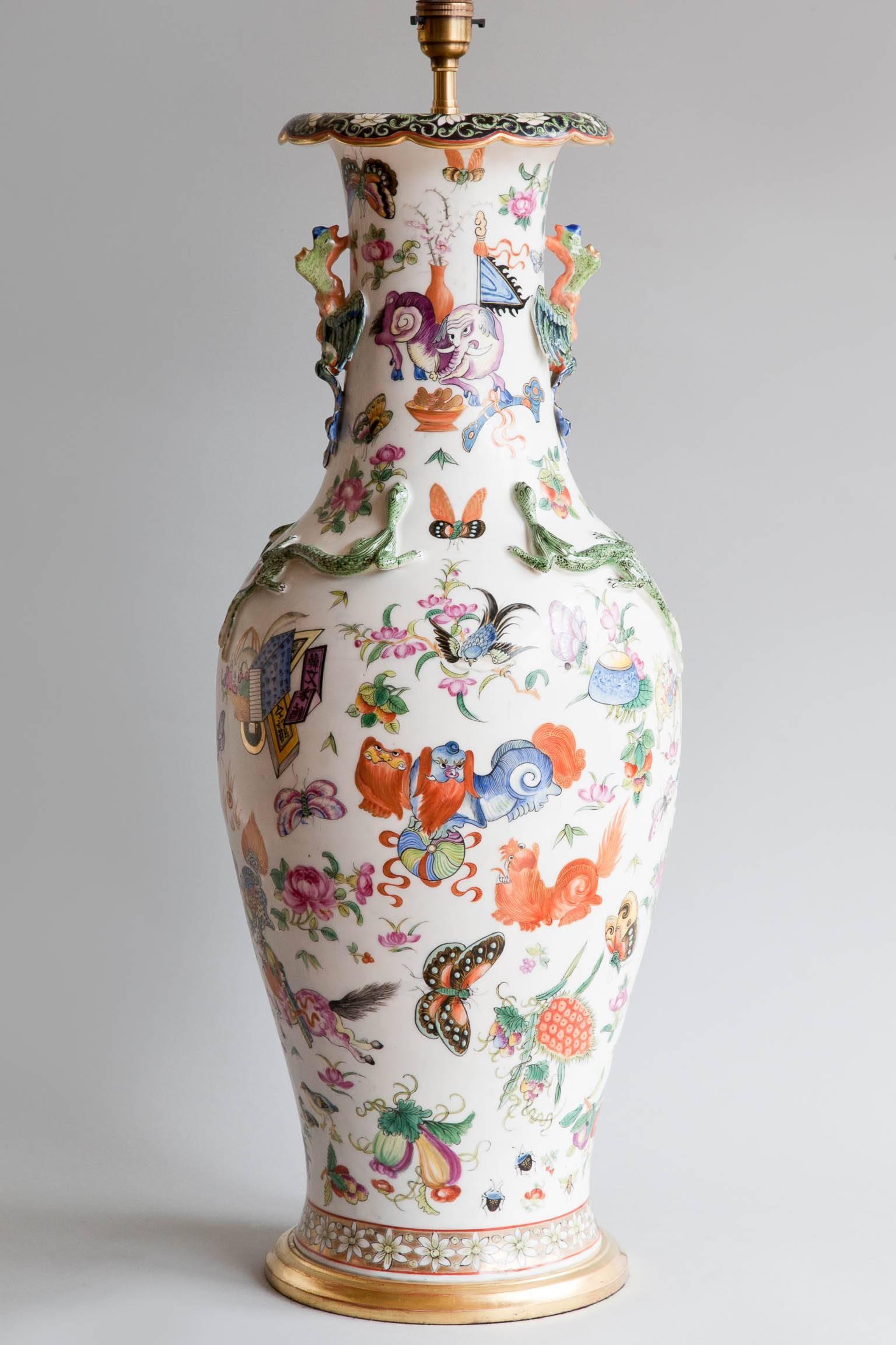 French porcelain vase in the chinoiserie taste. Decorated with dragons, lions, goats, chimera, butterflies and flowers.
The neck of the vase decorated with pheonix's and salamanders in relief.
Small chips to the porcelain, see pictures below.