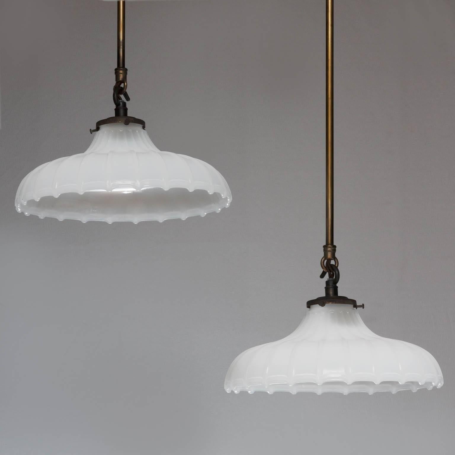 A pair of late 19th century milk glass ribbed shades with black bronze galleries and mounts, hung on two rods. Currently electrified for the UK.

We are members of LAPADA and CINOA.