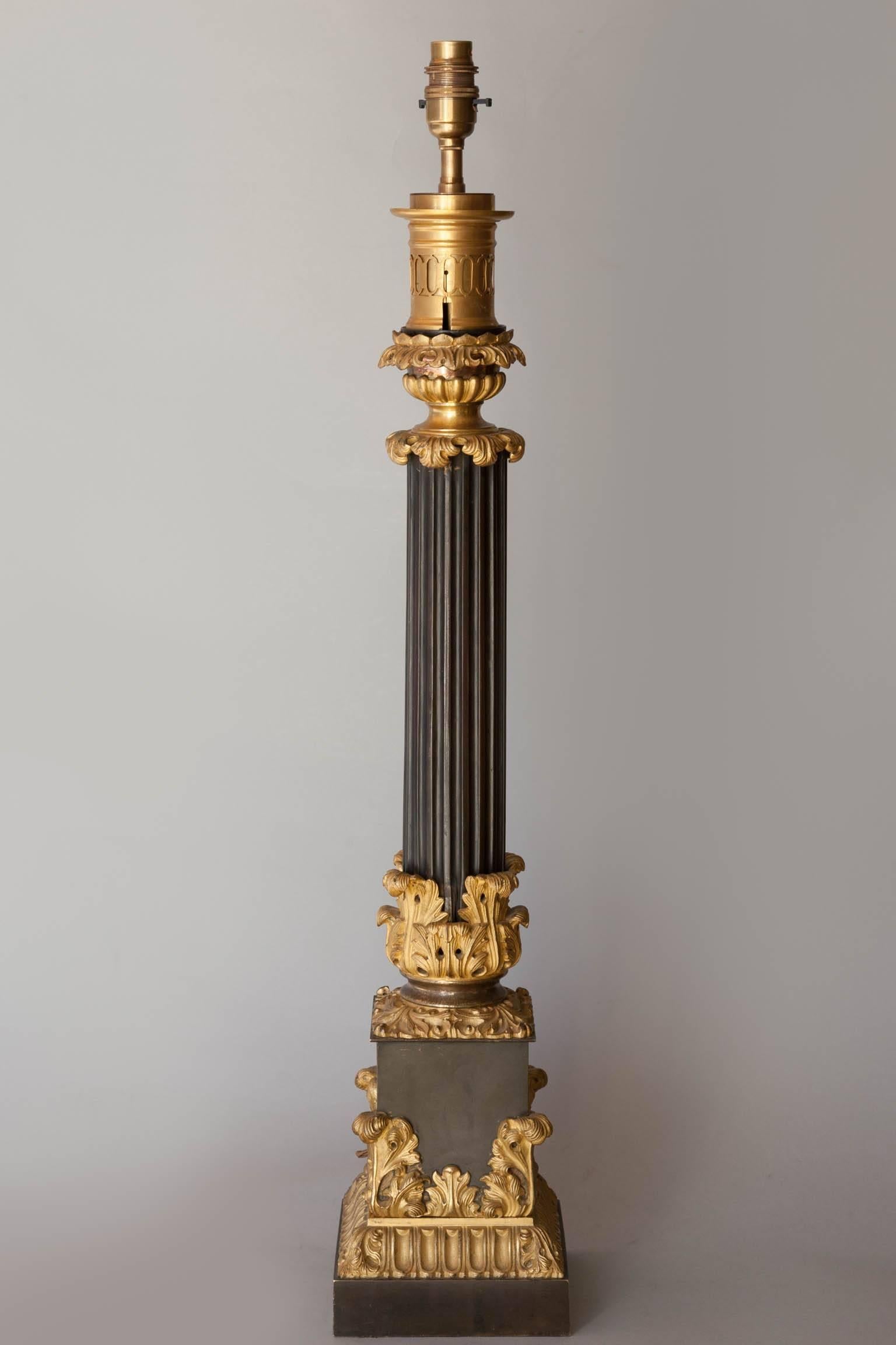 Tole and gilt bronze carcel lamp converted to a table lamp with ormolu acanthus leaf decoration on the central fluted column and plinth.
France, circa 1830. Currently electrified for the UK.
Shown with a 24" gathered rough silk shade available
