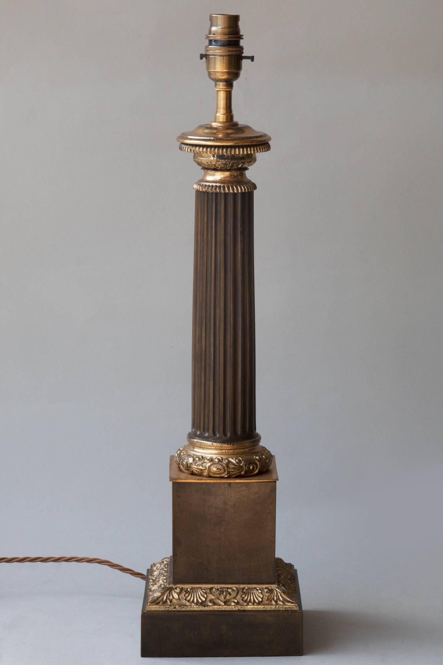 Gilt bronze mounts with foliat decoration in relief. Central fluted column supported on a plinth base, 
France, circa 1830. Currently electrified for the UK. Shown with a 18” silk shade available separately.