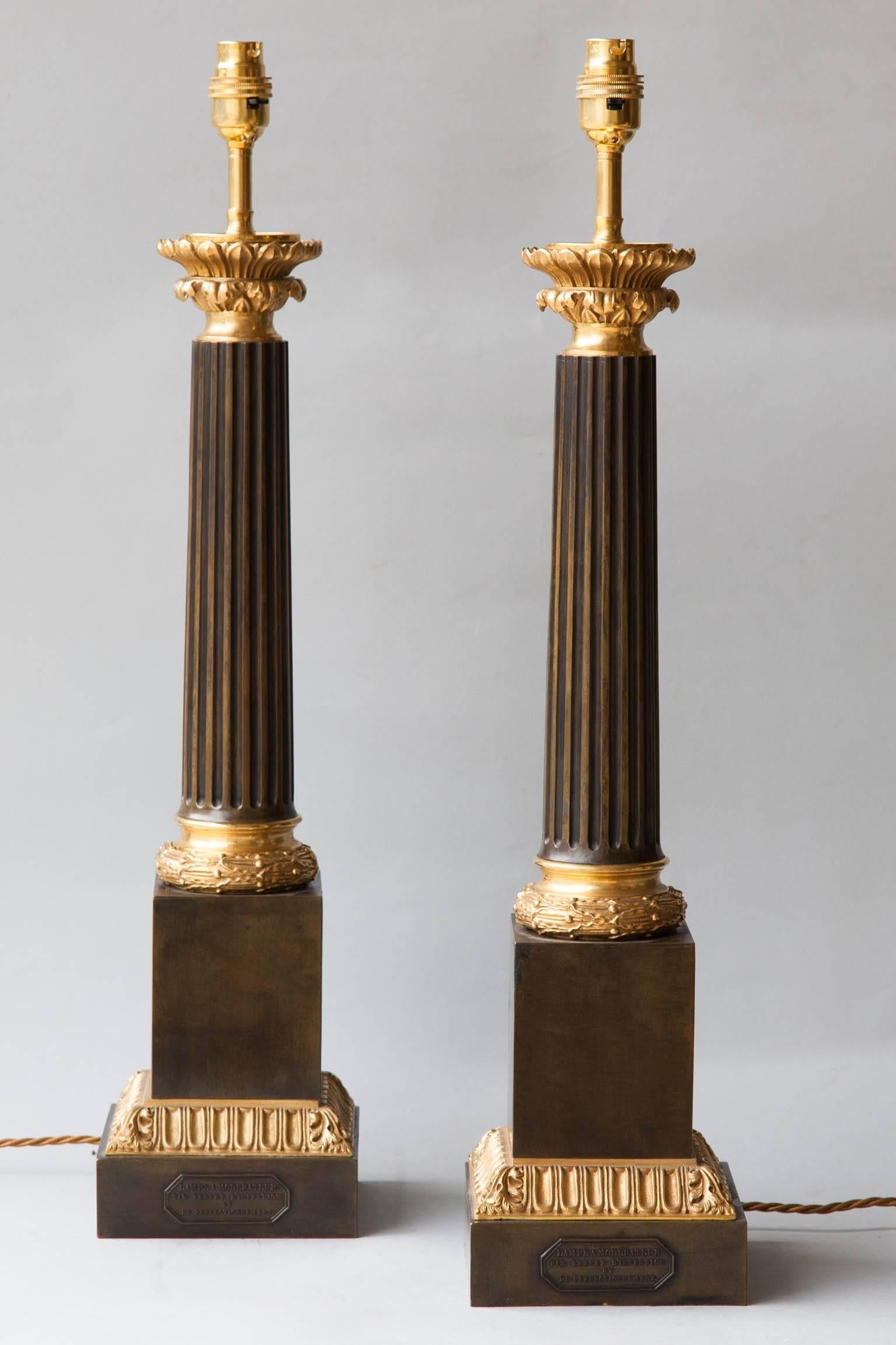 Gilt bronze mounts with foliat leaf and berry and acanthus leaf decoration in relief. Central fluted columns supported on a plinth base. 
Stamped 'Lampe a Moderateur/Par Brevet d‘Invention et de Perfectionnement', known as moderator lamps, this