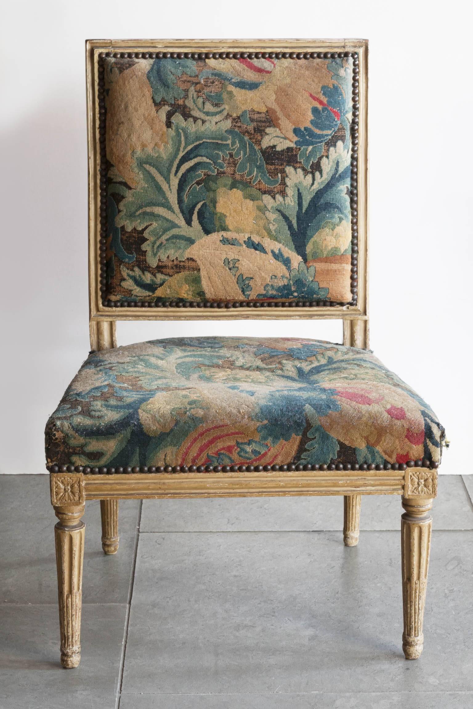 With four carved fluted legs, carved square back and carved rosettes on the corners of the apron. Original paintwork. Upholstered in petit point. Stamped by the maker, C. Séné on the underside of the seat frame,
France, circa 1785.
In original