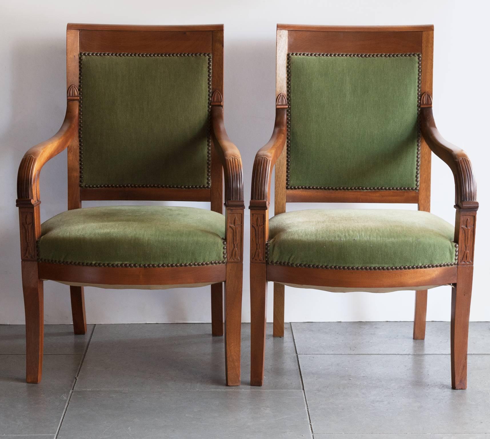A pair of carved mahogany open armchairs with green velvet nailed upholstery. With carved lotus leaf decoration.
Damage to the velvet on one of seats. France, circa, 1910.
  