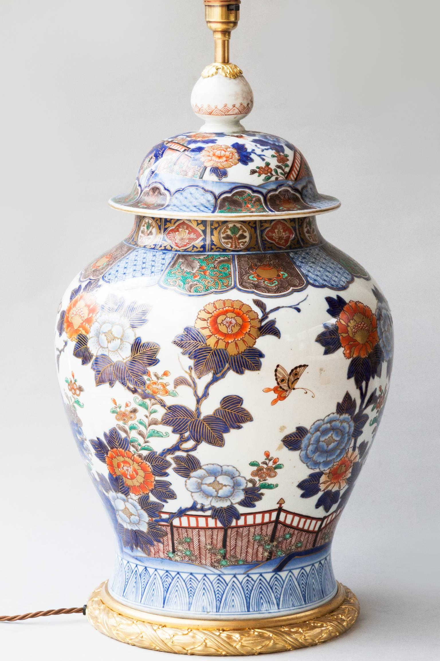 Large oviform porcelain vase with blue and red decoration on a white ground. 
With butterflies and stylised chrysanthemum, a flower identified with the Japanese throne.
Gilt bronze mounts. Japan, late 19th century.