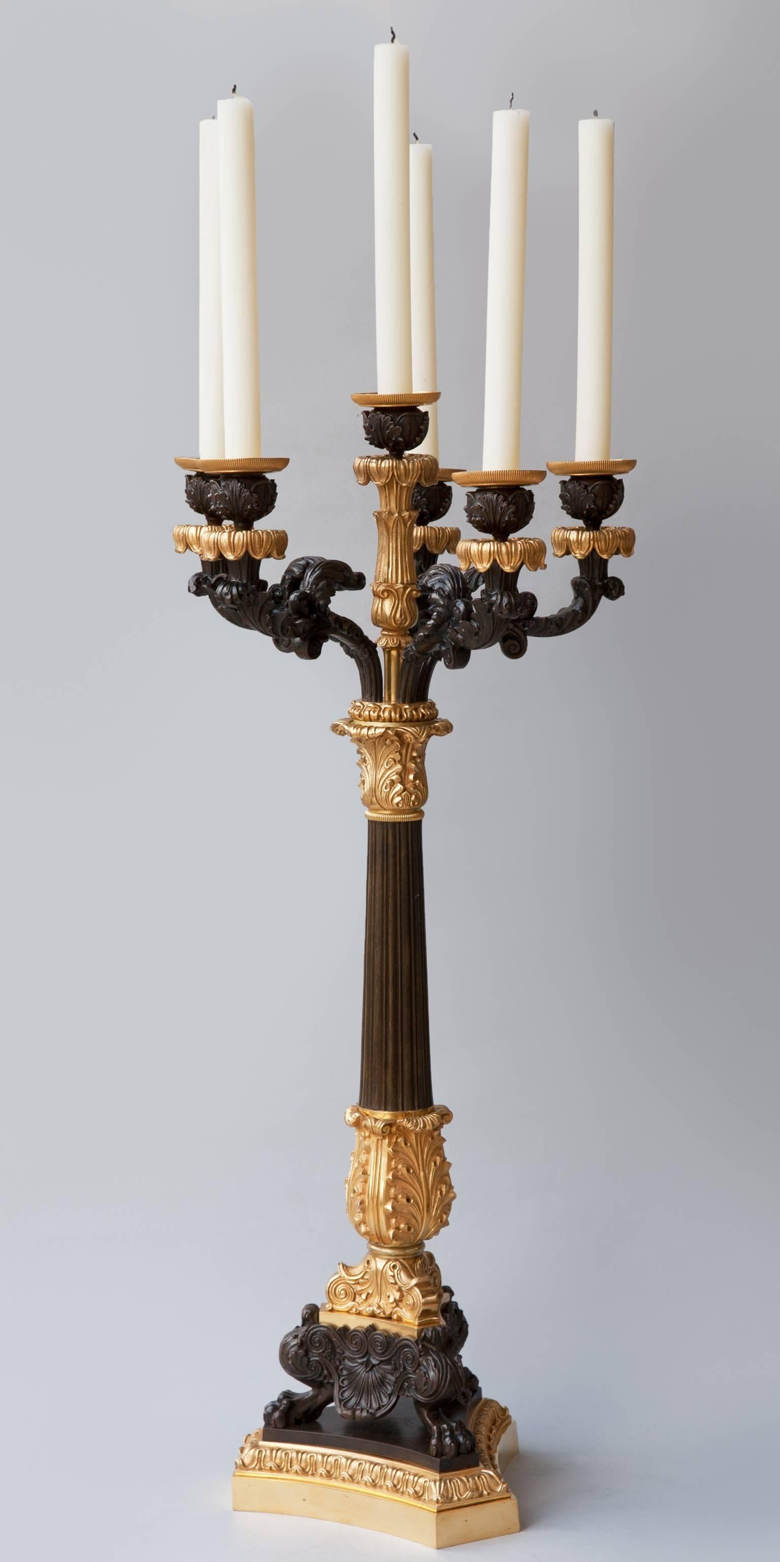 Five arms with gilt bobeche inside a patinated cup, each supported on a patinated arm decorated with acanthus leaves. A raised central sixth arm completes the top section which is detachable. The top slots into the central tapering and fluted