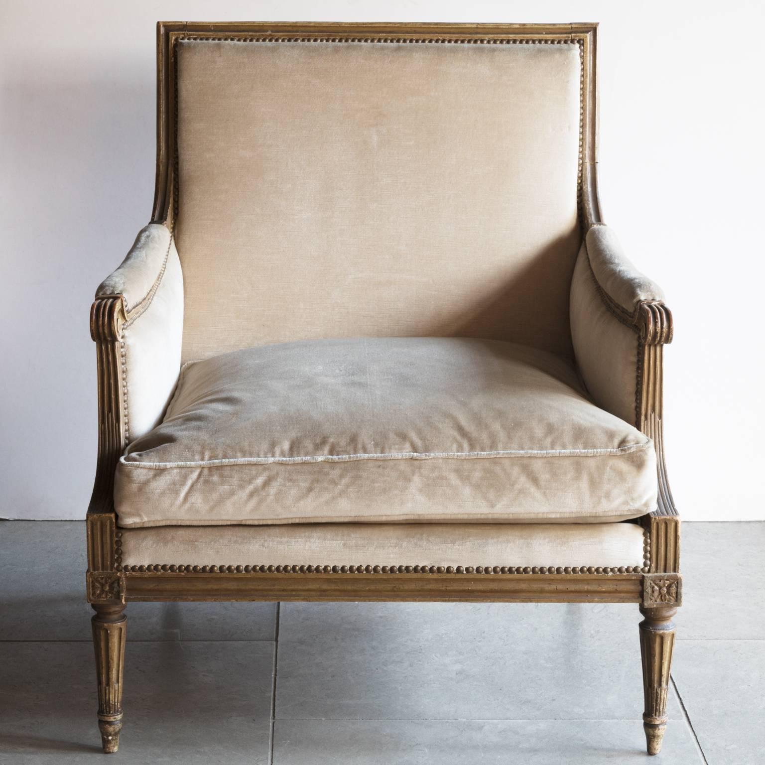 Pair of 19th century very large Louis XVI style armchairs. With fluted carving to the frame throughout, the arms
terminating in scrolls. Carved rosetts to the four corners of each seat. The timber covered with original green/grey paint. Upholstered