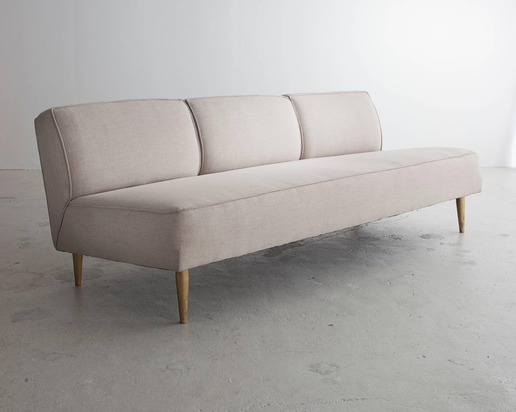 Three-seat sofa in white upholstery with tapered brass legs. Designed by Greta Magnusson Grossman for Martin Brattrud as a part of the 