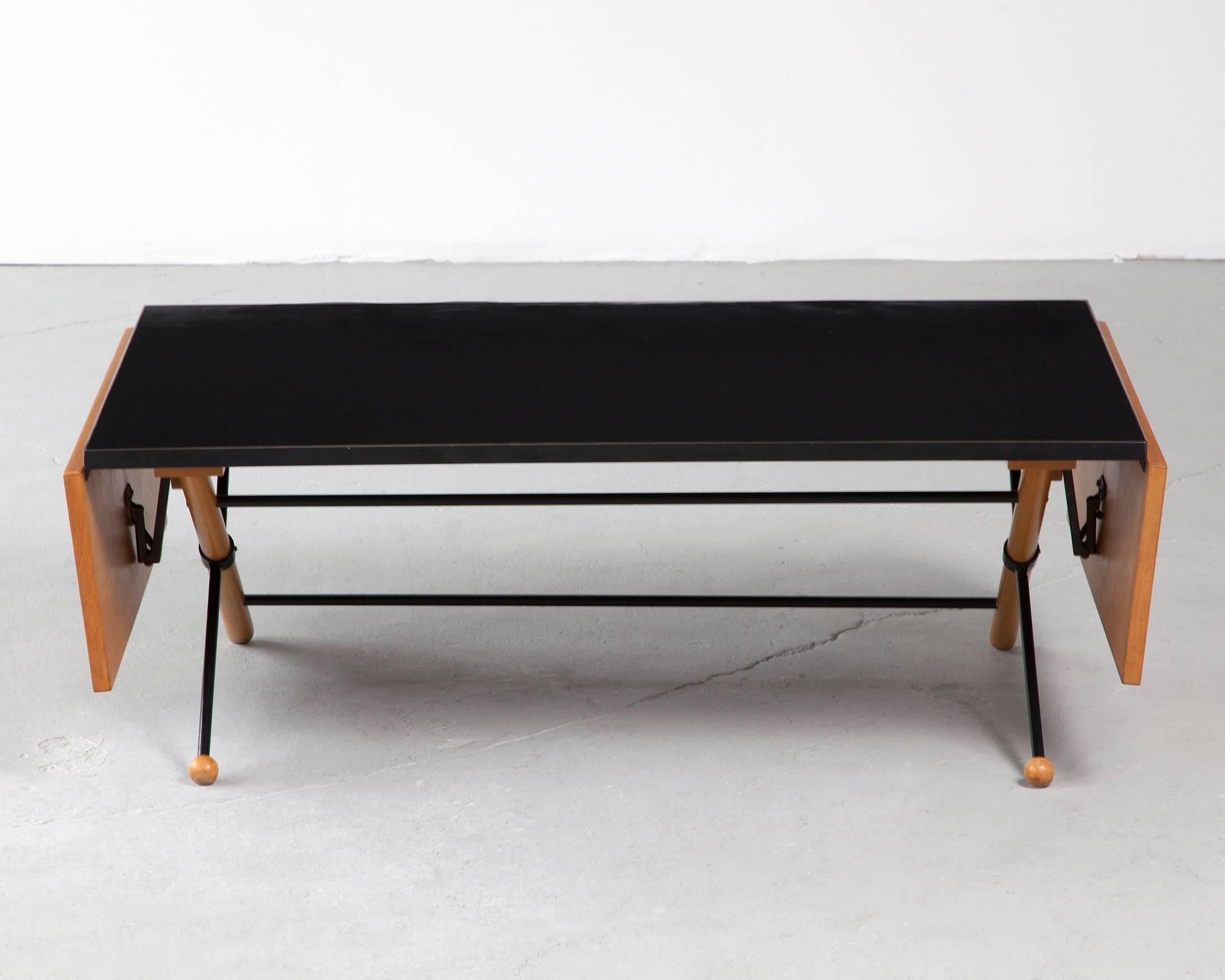 Coffee table in walnut, steel and plastic laminate with folding leaves. Designed by Greta Magnusson Grossman for Glenn of California, Los Angeles, 1952.