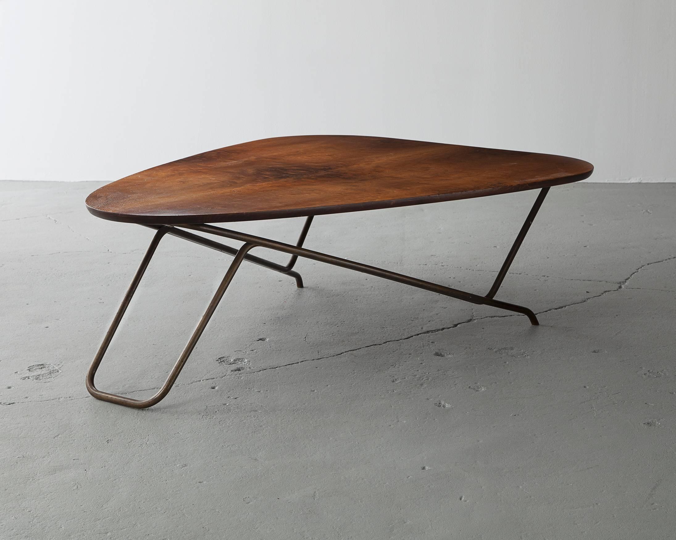 Wood coffee table with California walnut veneer and a sculptural brass base. This design is commonly referred to as the 