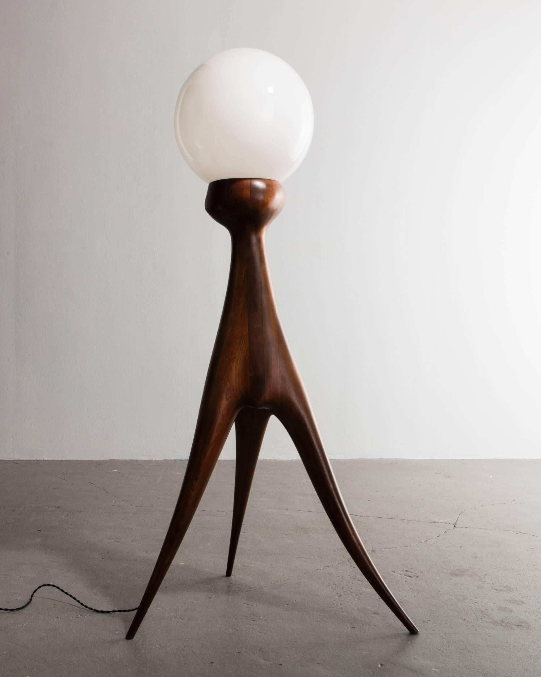 Unique hand-shaped floor lamp in stack-laminated walnut with glass globe. Designed and made by Wendell Castle, Rochester, New York, circa 1966.