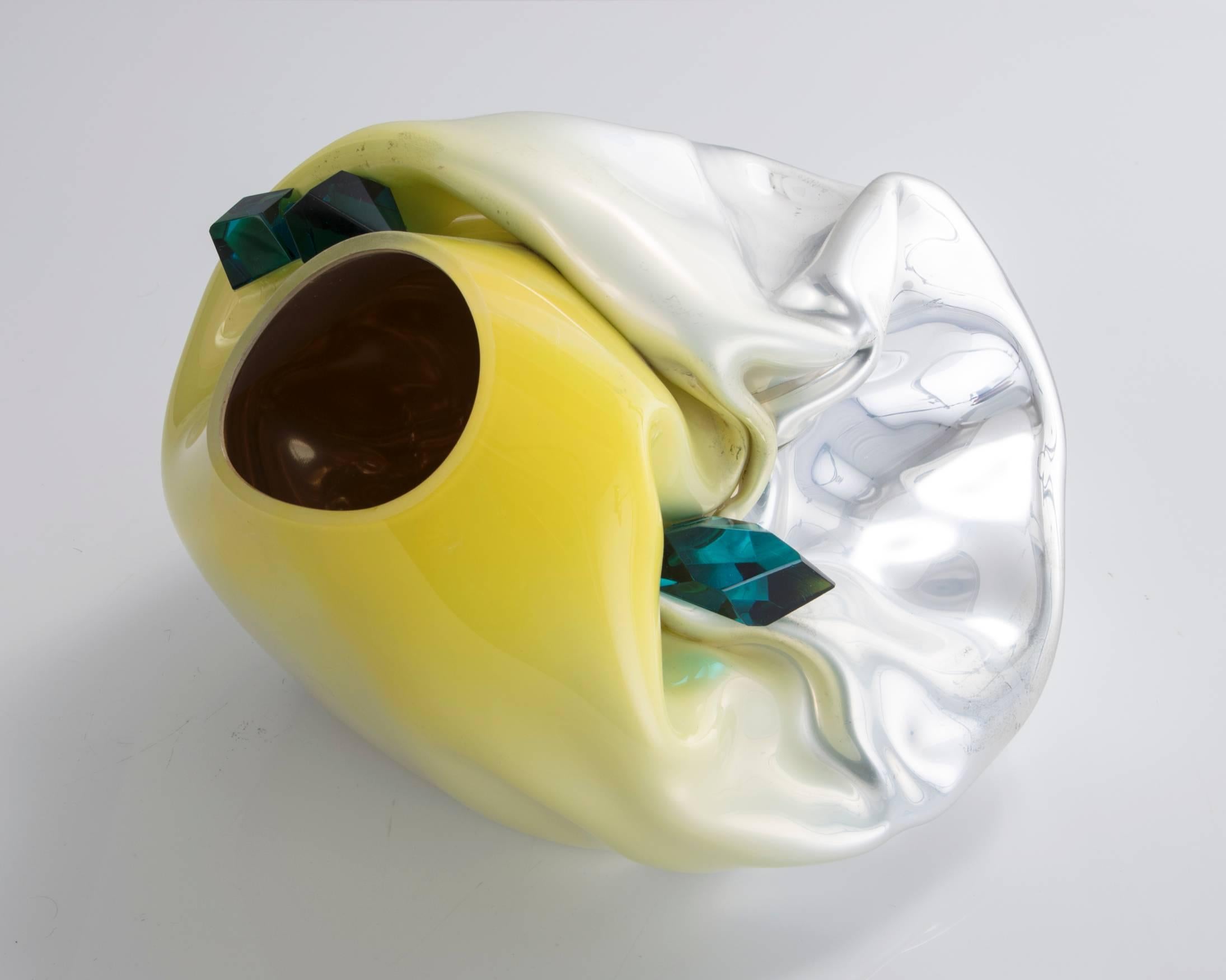 Unique crumpled sculptural vessel in silver mirrorized handblown glass with yellow-colored top and jade green glass crystals. Designed and made by Jeff Zimmerman, USA, 2016.