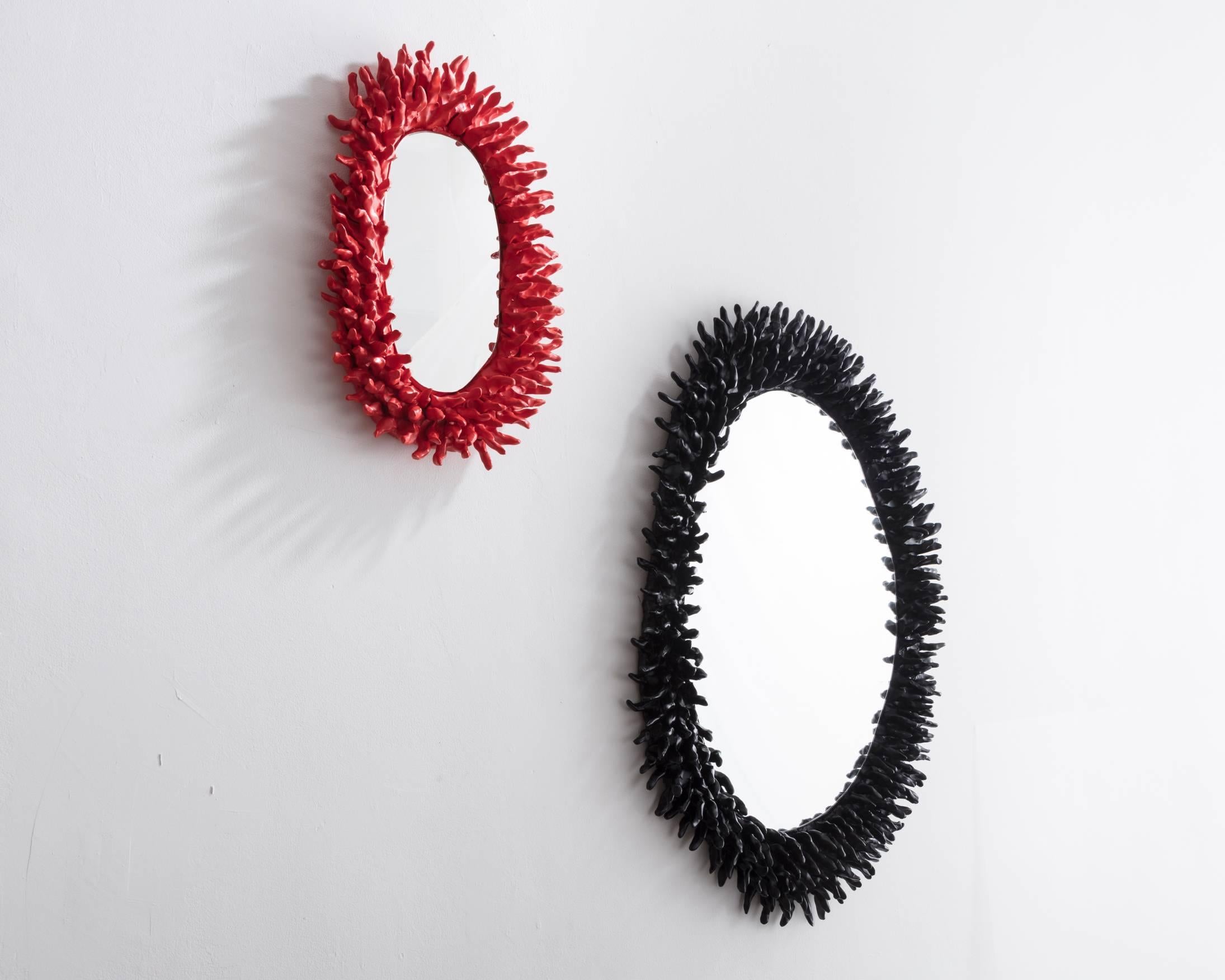 Large Spiky wall mirror in black ceramic. Designed and made by Katie Stout, USA, 2017.