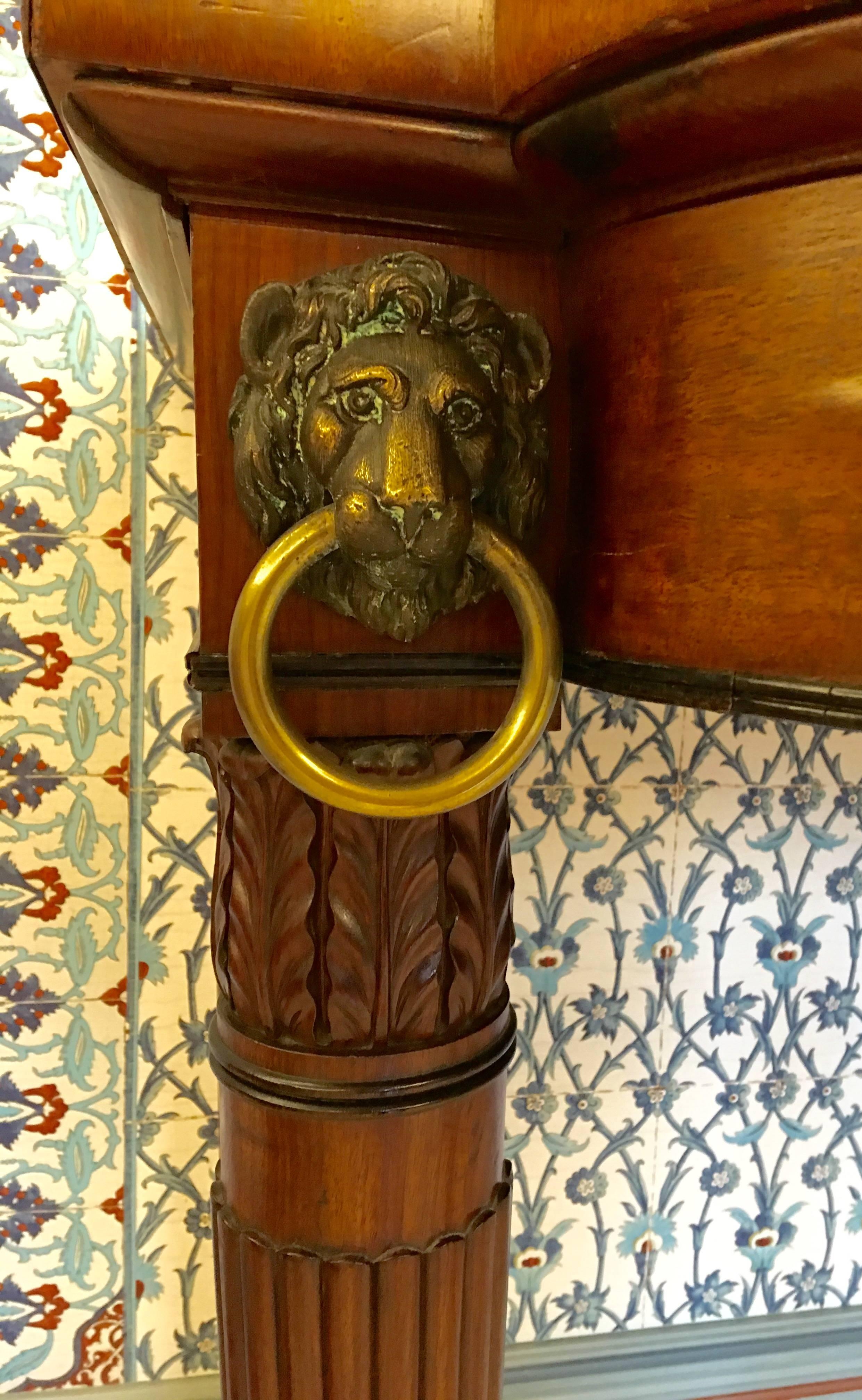 19th century English late Regency mahogany server with lion heads brass mounts.