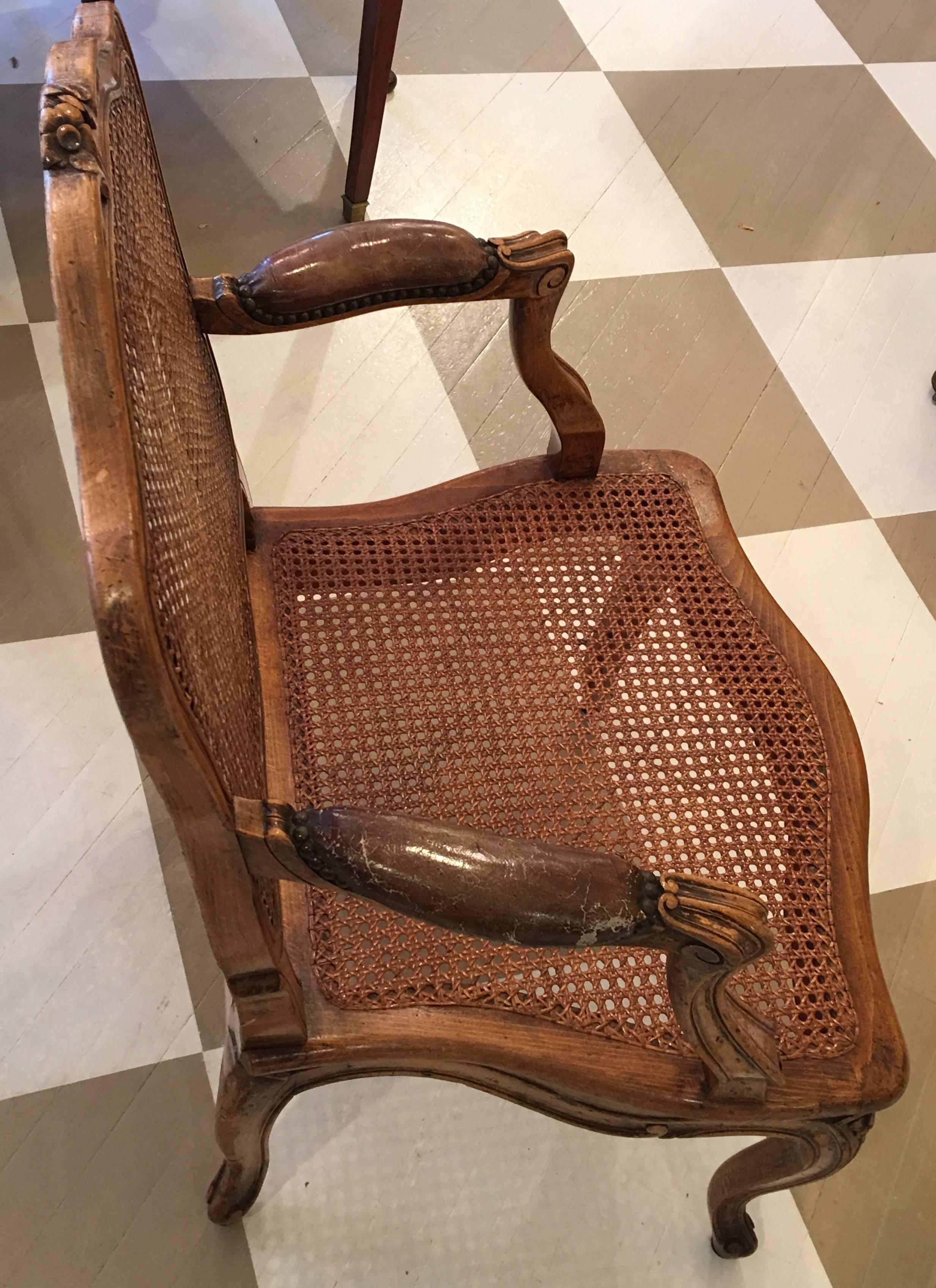 Pair of 19th century French Louis V Style Fruitwood and Cane armchairs. 
Napoleon III Period circa 1860's
having the original brown leather on the arms