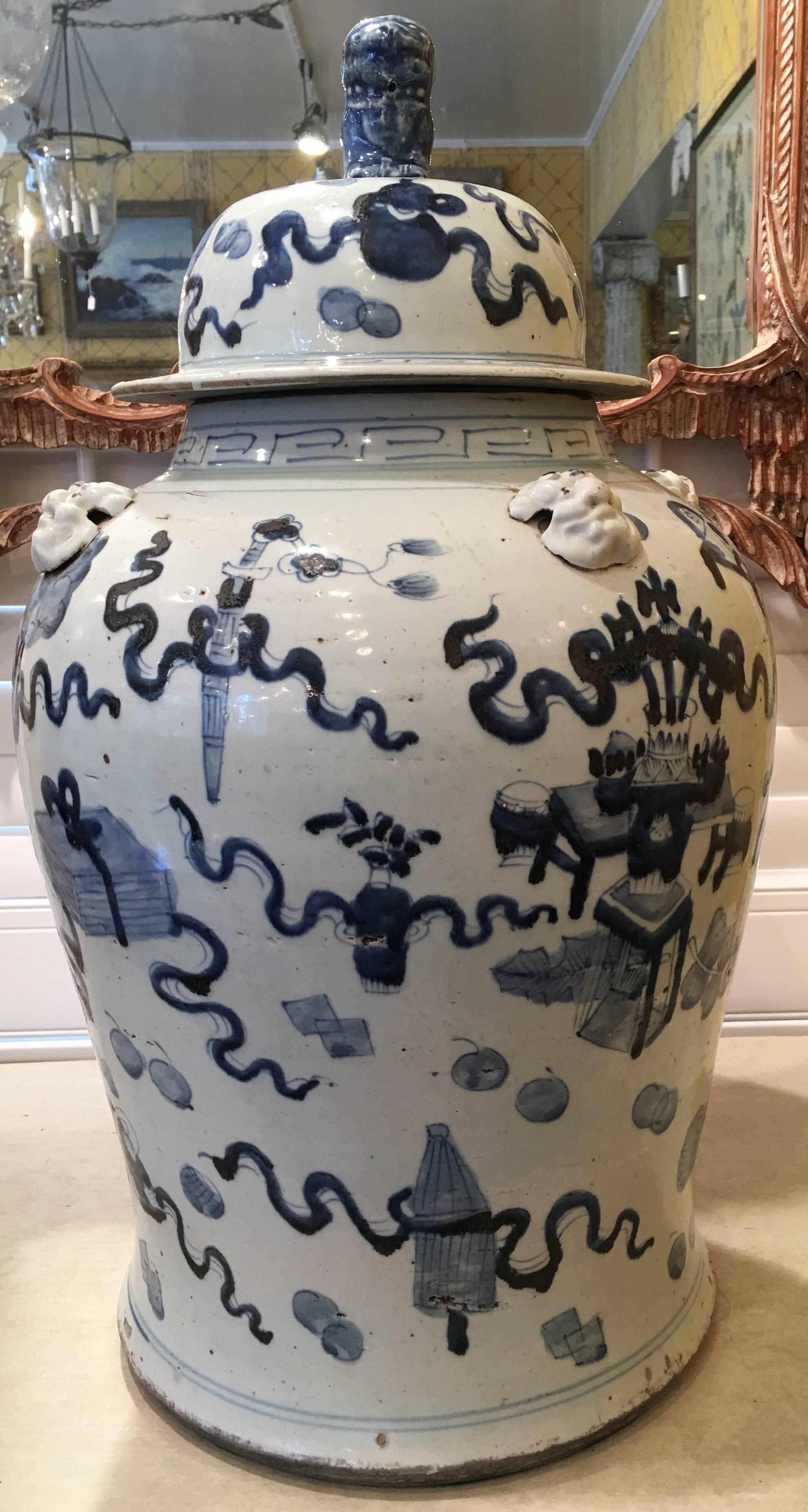 Pair of Late 20th Century Chinese blue and white temple jars with lion figure mounted on top of lids,
Late 20th Century, Qing style.