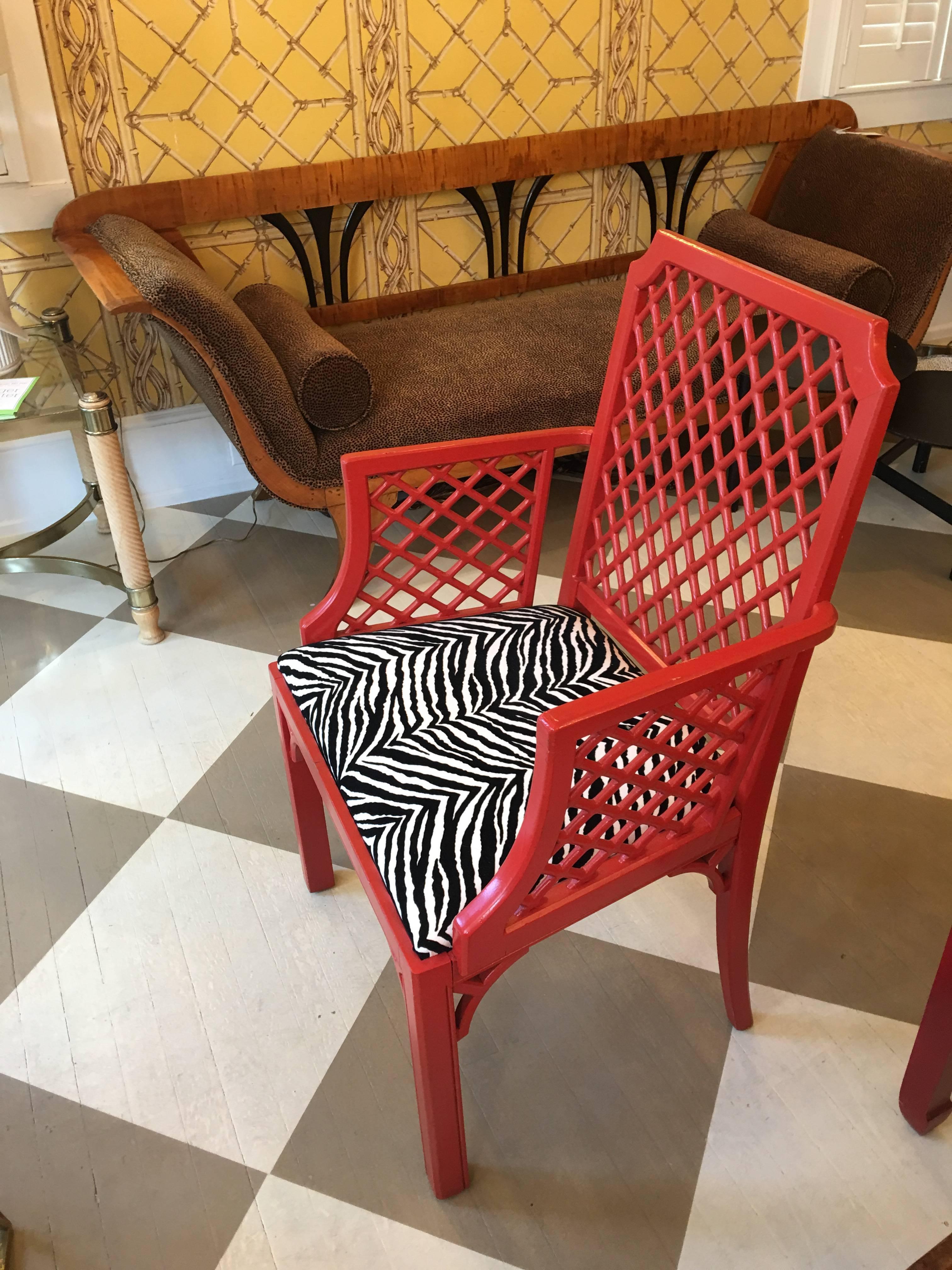 Late midcentury American set of eight red painted Trellis style dining room chairs, circa 1970
having two armchairs, cane seats, and newer zebra cushions.