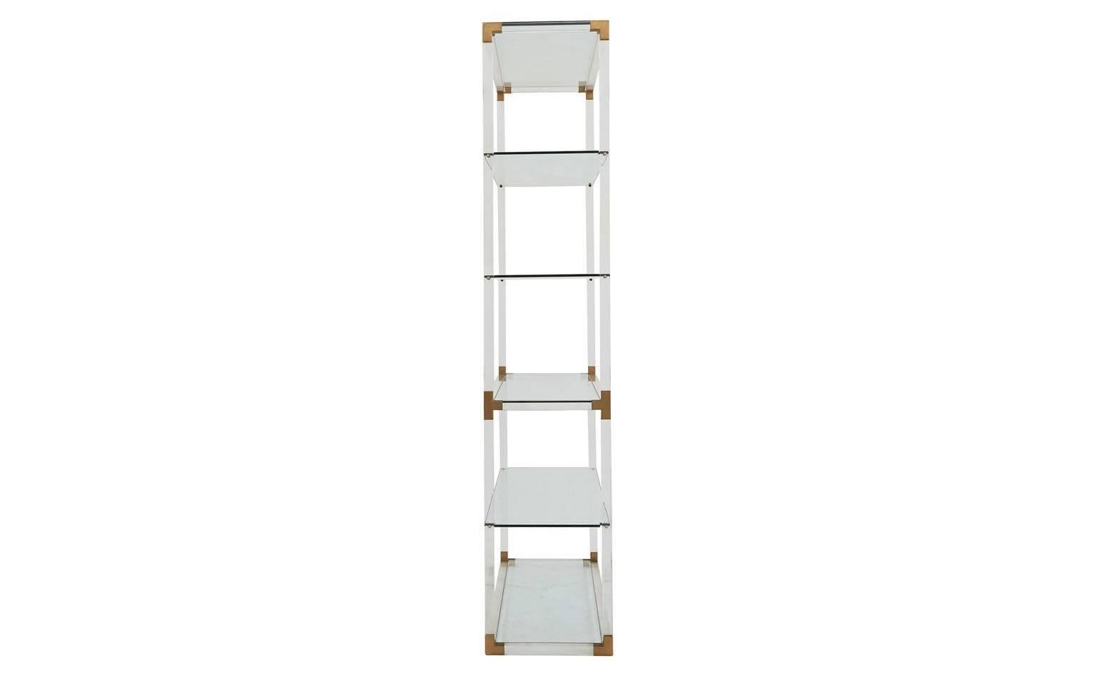 Five glass shelves
Lucite frame with brass detail
Mid-20th century
Barcelona.
Measures: 47'W x 16'D x 78.5'H