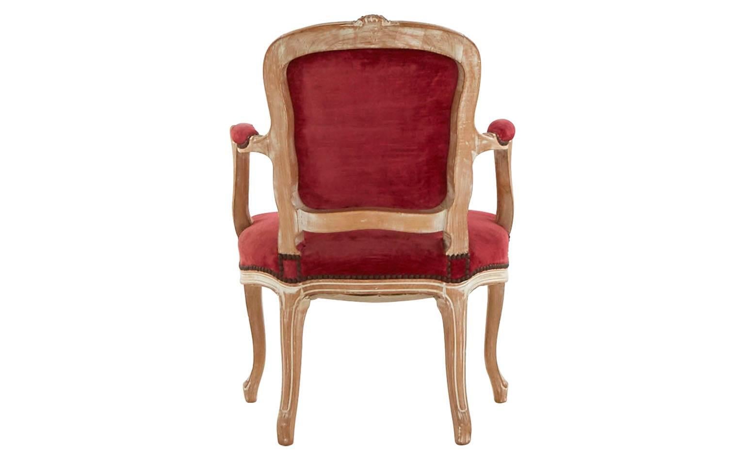 Louis XV style.
Original raspberry velvet upholstery.
Hand-painted ivory wood frame
20th century.
France.
Set of two available (priced individually).

Dimensions:
Overall: 22.5" W x 20" D x 33.5" H. 
Seat height: