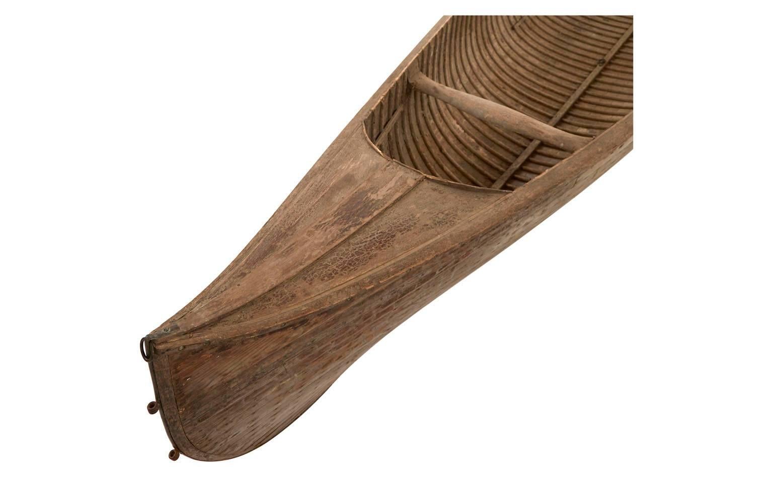 Hand-carved wood canoe with two oars and three seat posts.
Made in France.
Measures: 35'D x 190'W x 21'H