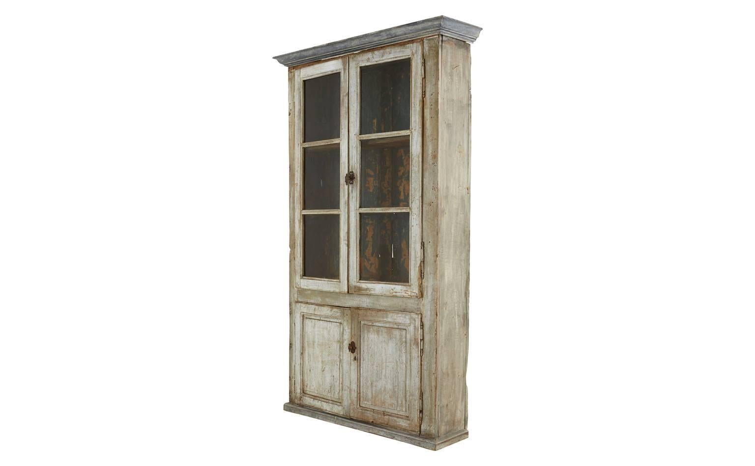 Antique cabinet. Painted weathered finish as found. Remnants of wallpaper on interior.