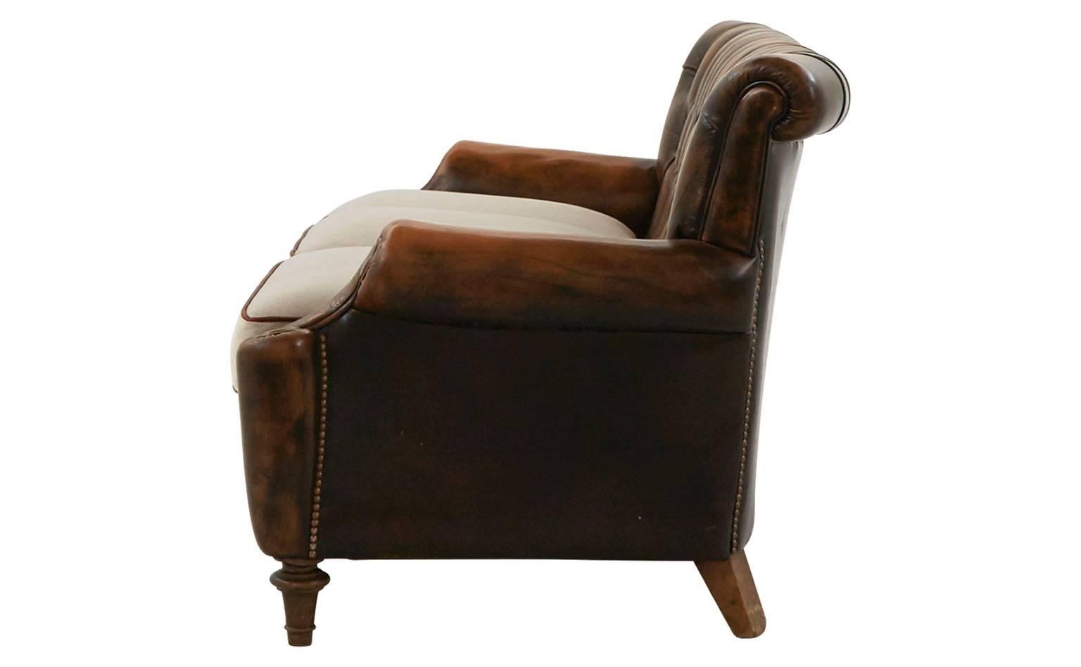 Original tufted leather.
Reupholstered in natural linen with leather welt,
20th century,
Barcelona.

Dimensions:
Overall: 75" W x 35" D x 30" H.
Seat height 18" H.
Arm height 21" H.