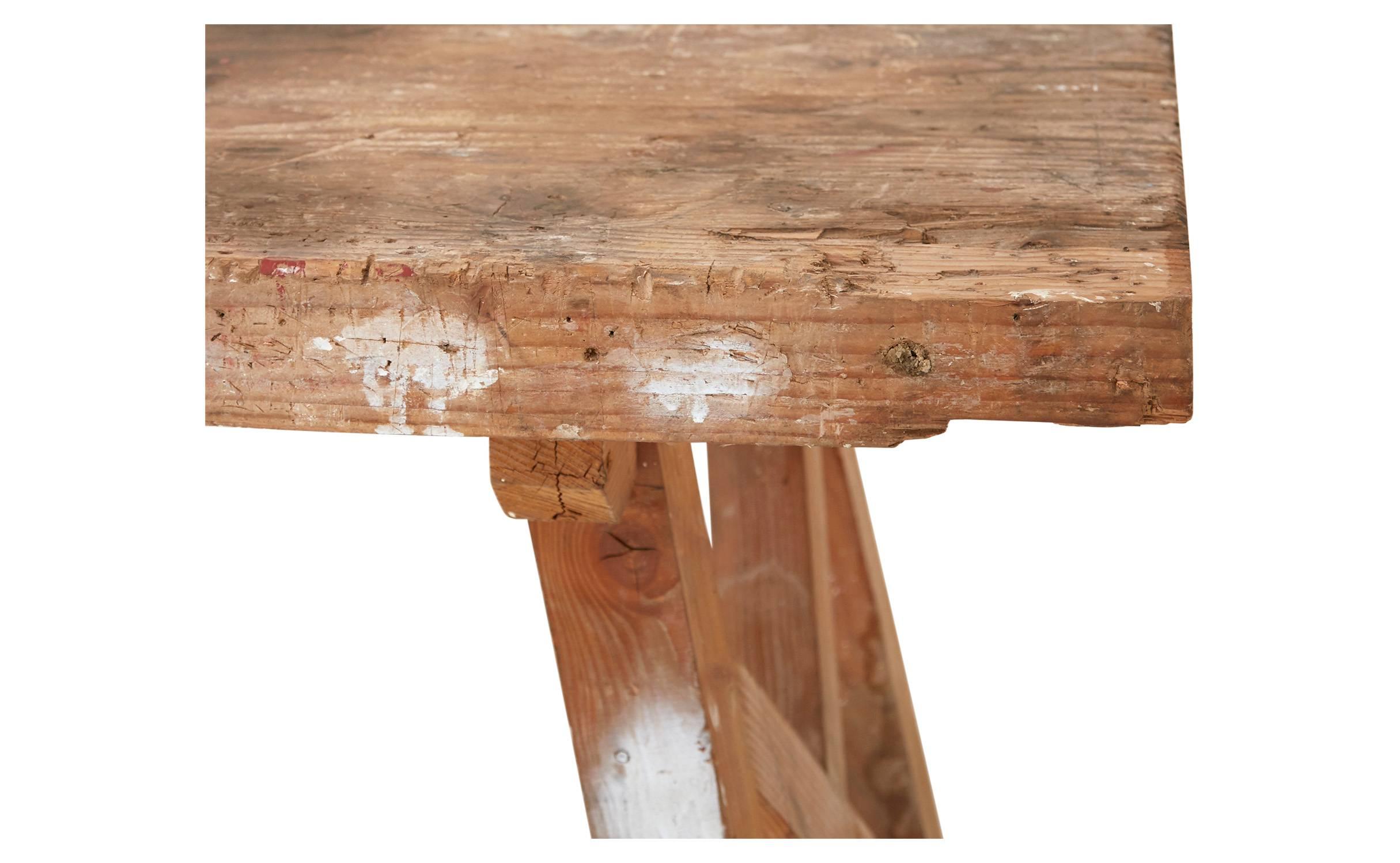 Crafted from wood in the 20th century, our weathered Vintage Carpenter Console was salvaged from a workshop in France. Naturally distressed after years of use, this sturdy worktable has taken on a nice patina over the years, with natural scratches,