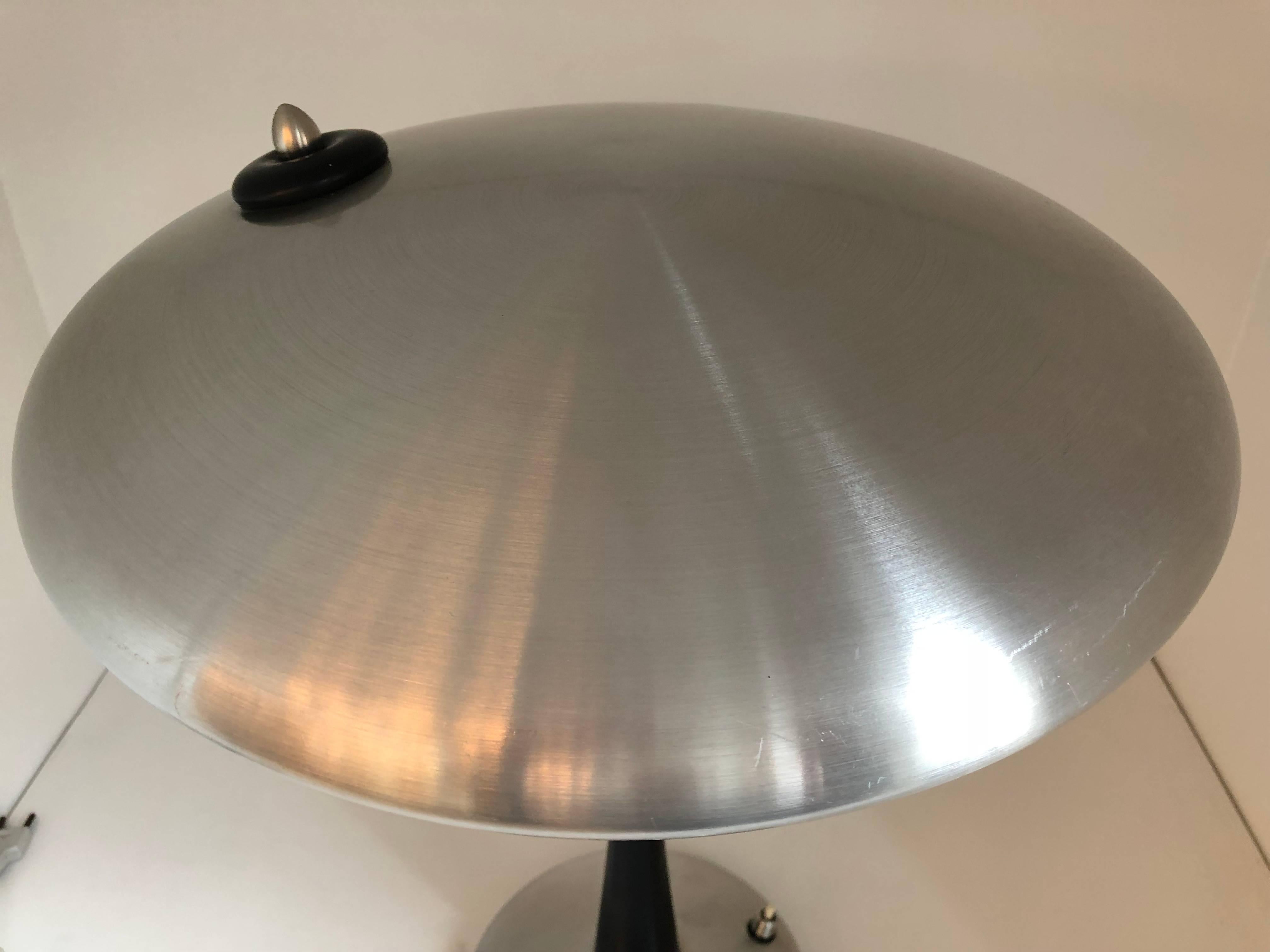 Italian task lamp designed by Oscar Torlasco for Lumi in the 1960's.  This distinguished lamp has a 
stainless steel base, black cone shaped stem and stainless steel adjustable round shade.  