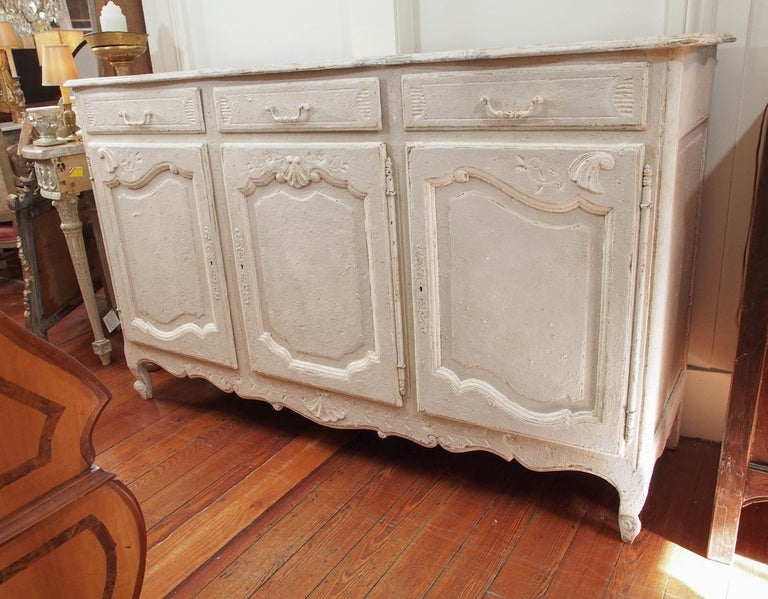 Late 19th century three doors and three top drawers painted buffet in white. The top is a faux marble finish in white and grey. Louis XV style
