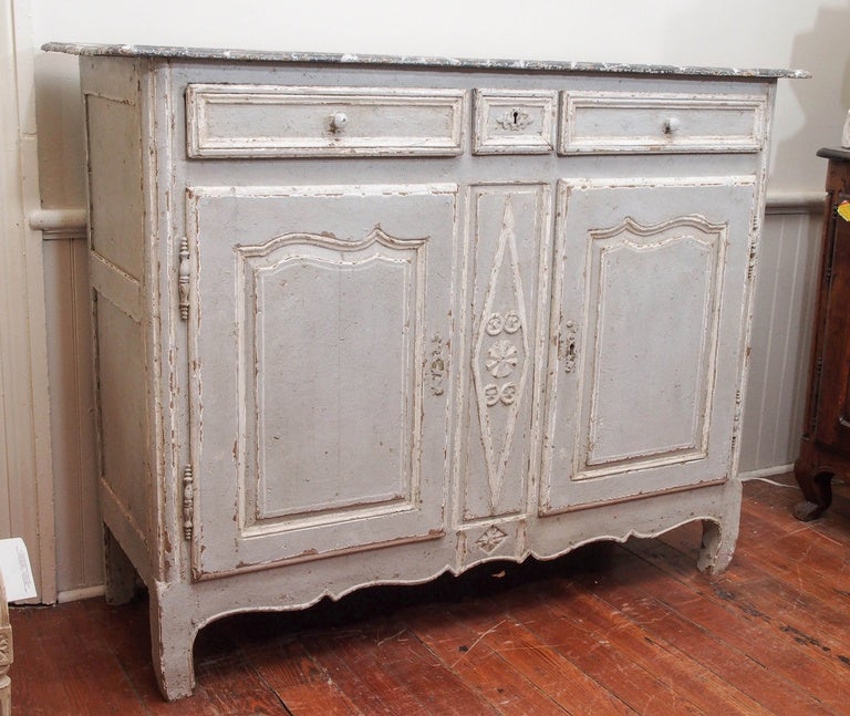 19th Century French painted buffet in a pale blue and white trim. The top is faux marble in grey and white. Two top drawers with a small one in the center and two bottom doors. Louis XVI style