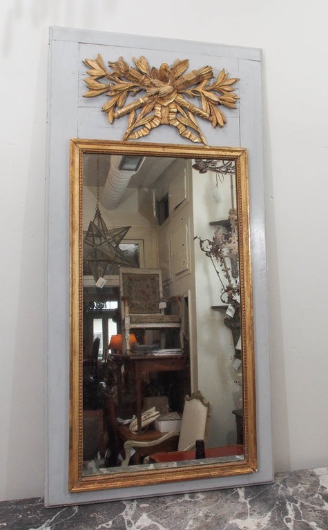 19th century French trumeau mirror painted in a French blue. Inside mirror framed with giltwood. Classical dove and flowers gilt cartouche motif.