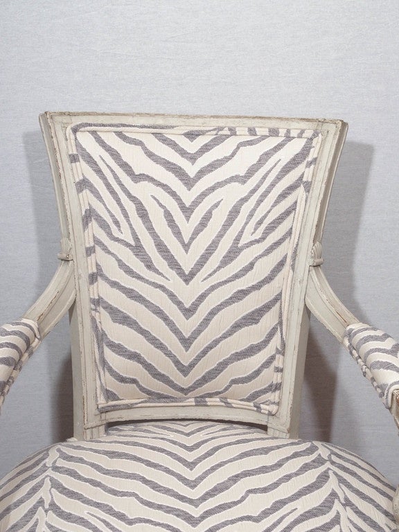 Pair of period  Directoire fauteuils 18th century painted in pale cream. Newly upholstered with white and grey stripe fabric.