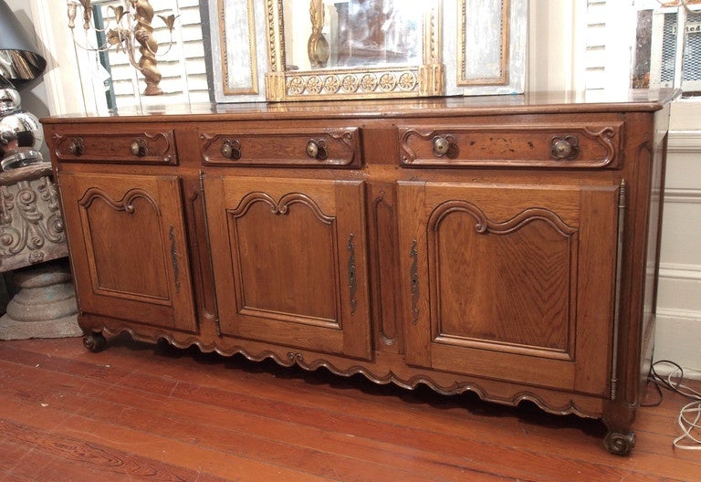 18th Century Louis XV walnut side board. 3 drawers 3 doors. scrolled feet