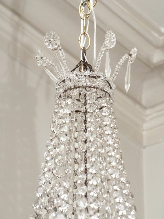 Small 19th Century empire style crystal chandelier. US wired with a cluster of 3 lights inside the chandelier.