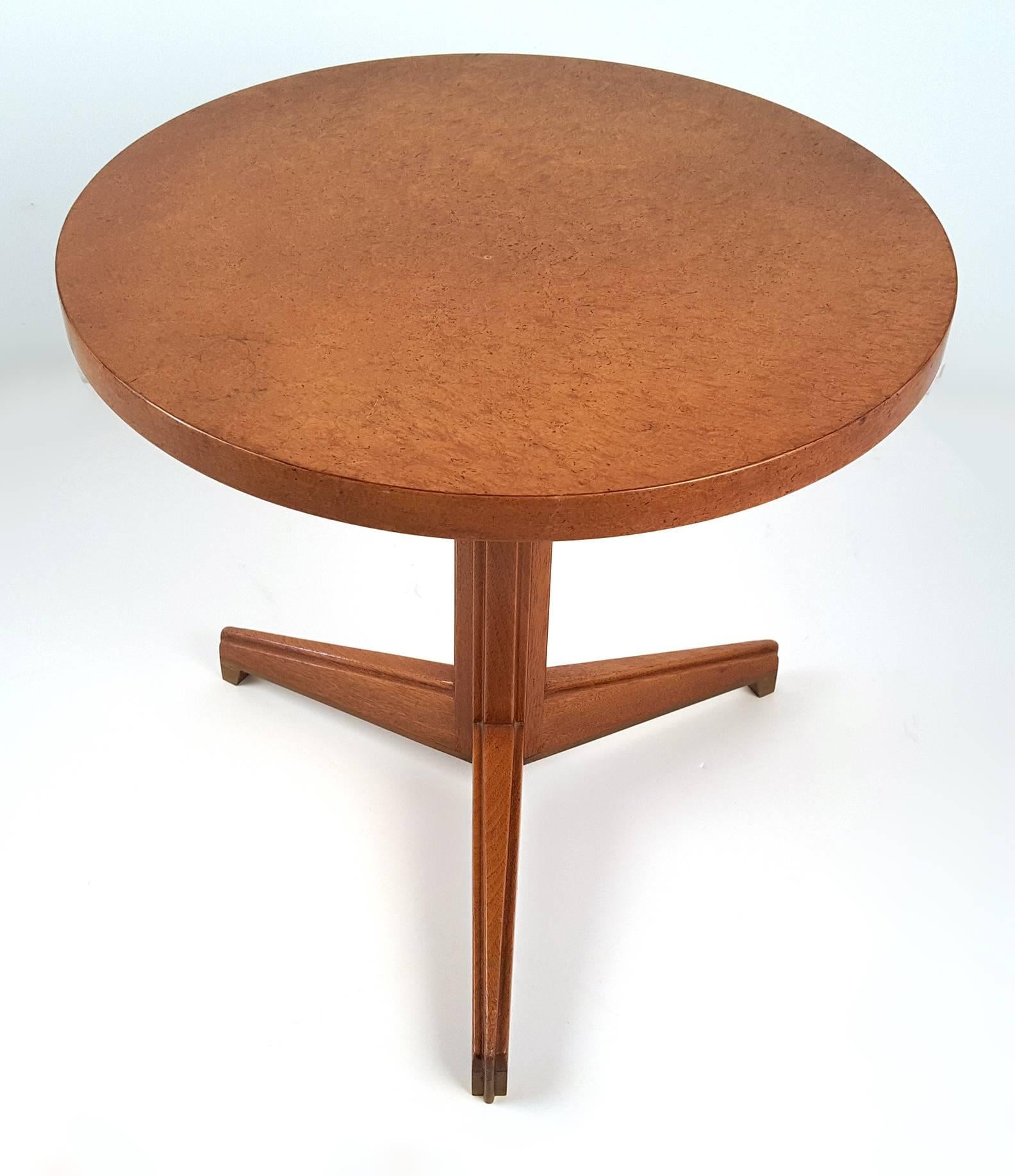 Stunning tripod side table by Edward Wormley for Dunbar from the Famous 'Janus' Collection. Stunning exotic wood top and solid brass feet. Original condition. Retains brass rectangular label.