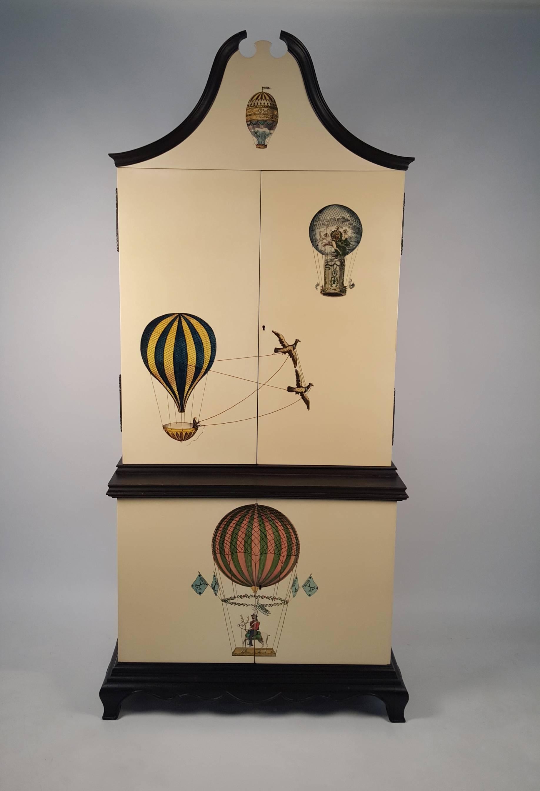 Whimsical vintage custom Trompe l'oeil cabinet adorned with lithographic depictions of 18th Century Hot Air Balloon Illustrations by German Artist K.G. Lohse including his famous work 'The ascension of Margat and his stag Coco.' Includes the two