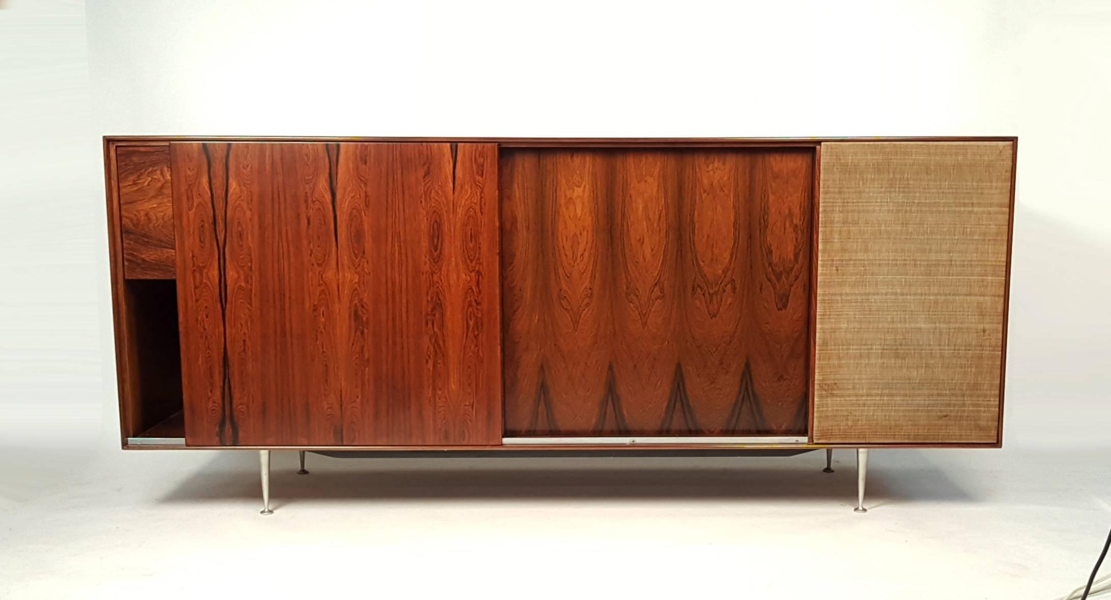Rare Brazilian rosewood cabinet by George Nelson for Herman Miller with drop front panel that opens to reveal the original Garrard RC-80M Turntable and Harmon Kardon Festival Mullard El 37 Tube powered integrated receiver. Both Electronic pieces are