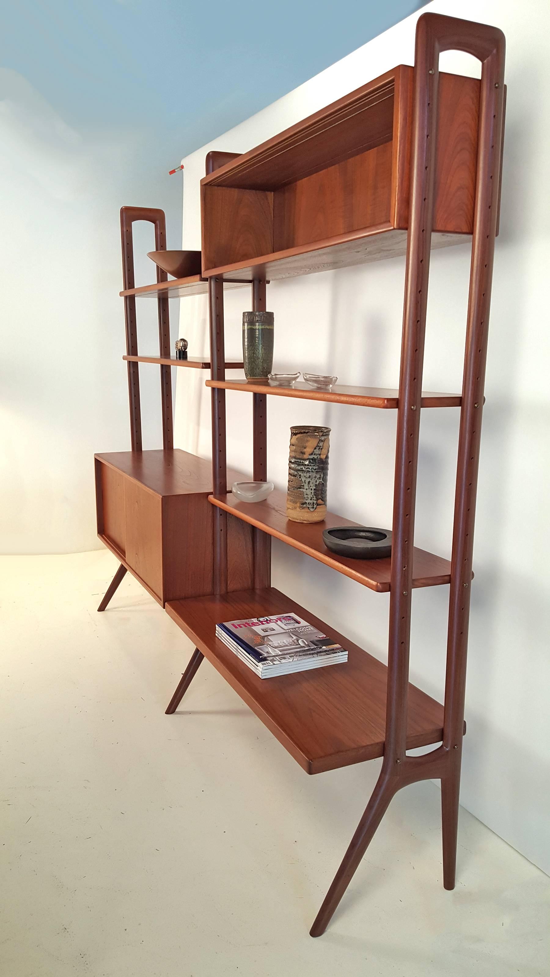 Kurt Ostervig designed freestanding Danish Modern wall unit in teak wood. Manufactured in Scandinavia in the 1960s. This Minimalist wall unit has been completely refinished and is in excellent condition. The shelves and cases can be re-arranged to